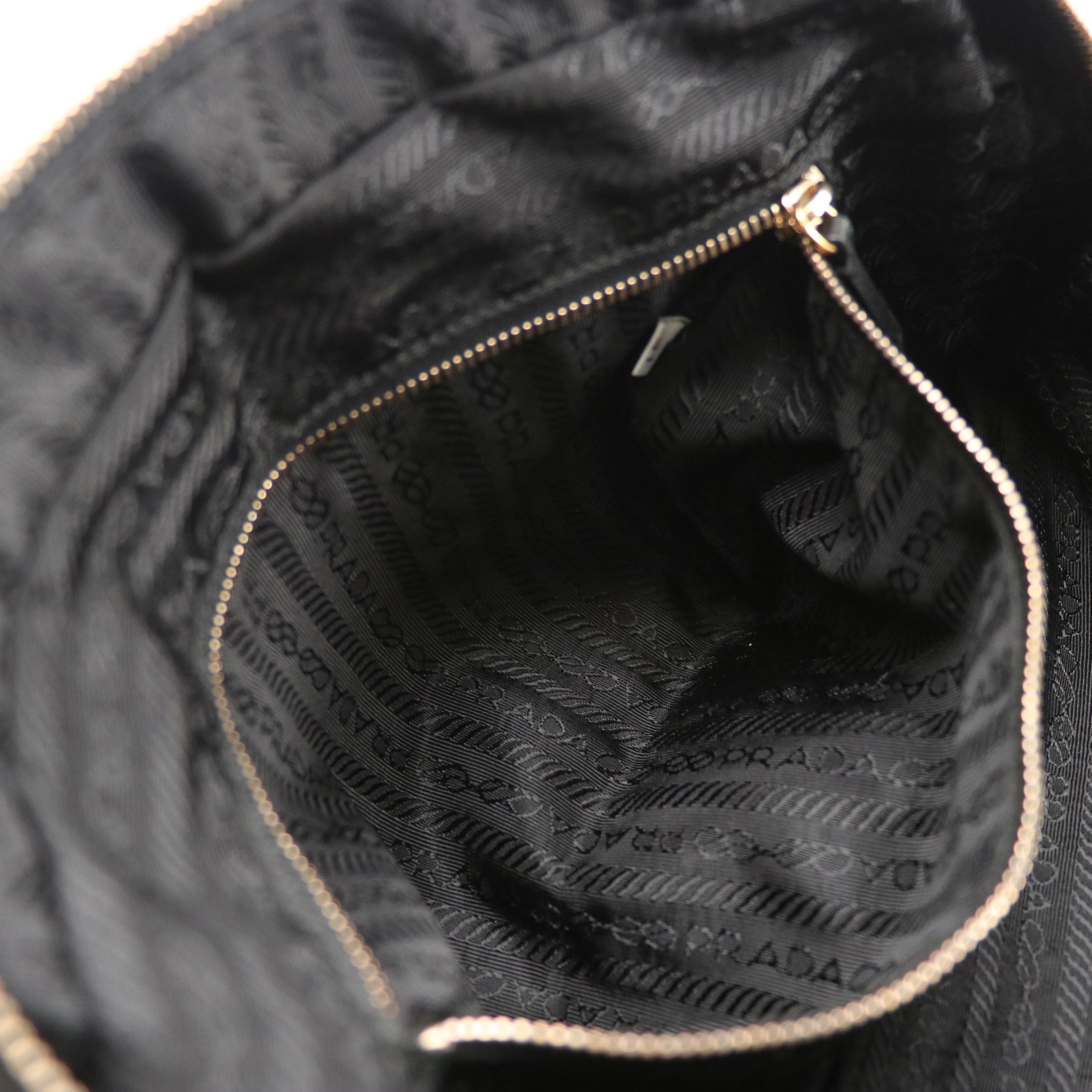 Prada Grommet Embellished Zip-Around Handbag in Black Nappa Leather