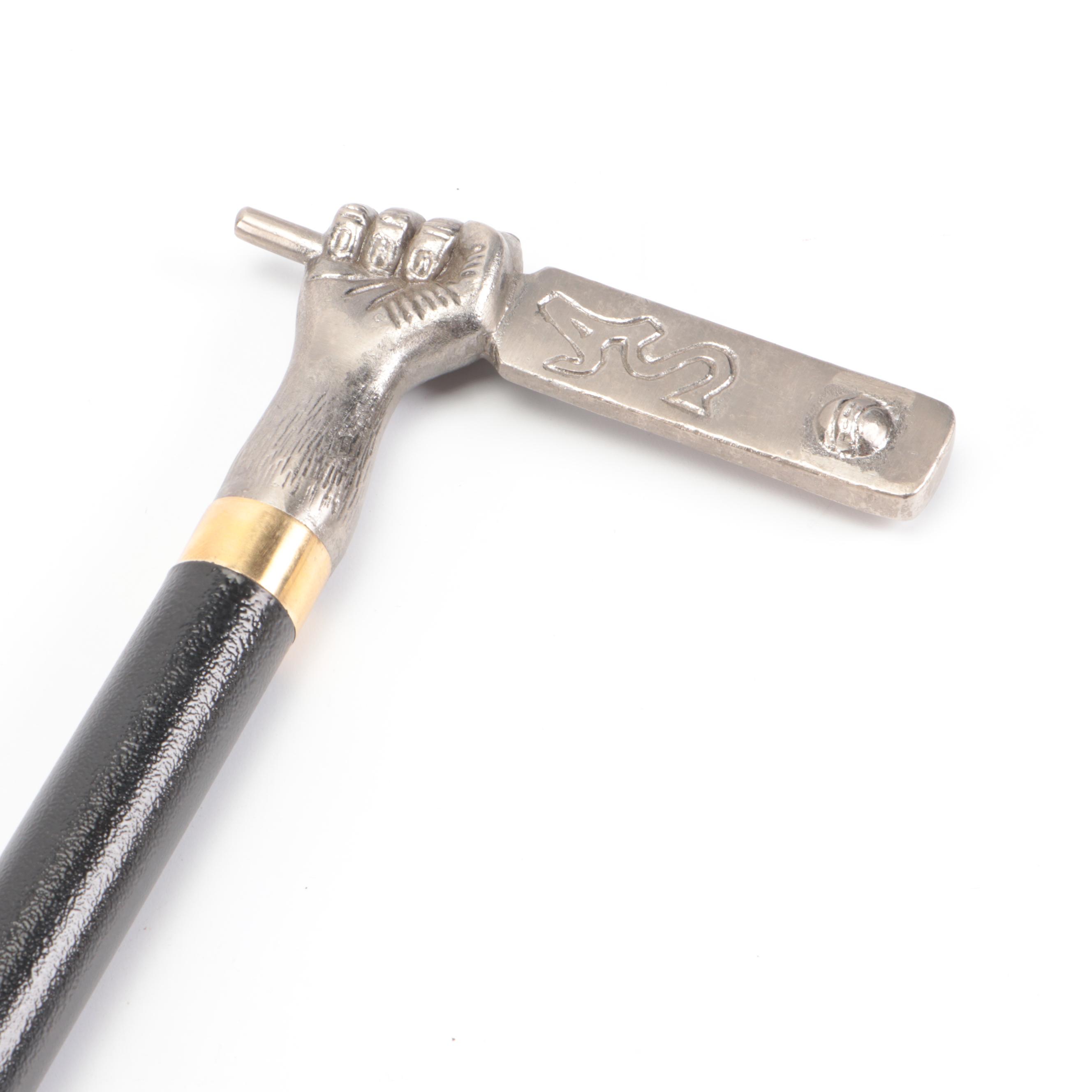 Hand Holding Paddle Handled Sword Cane