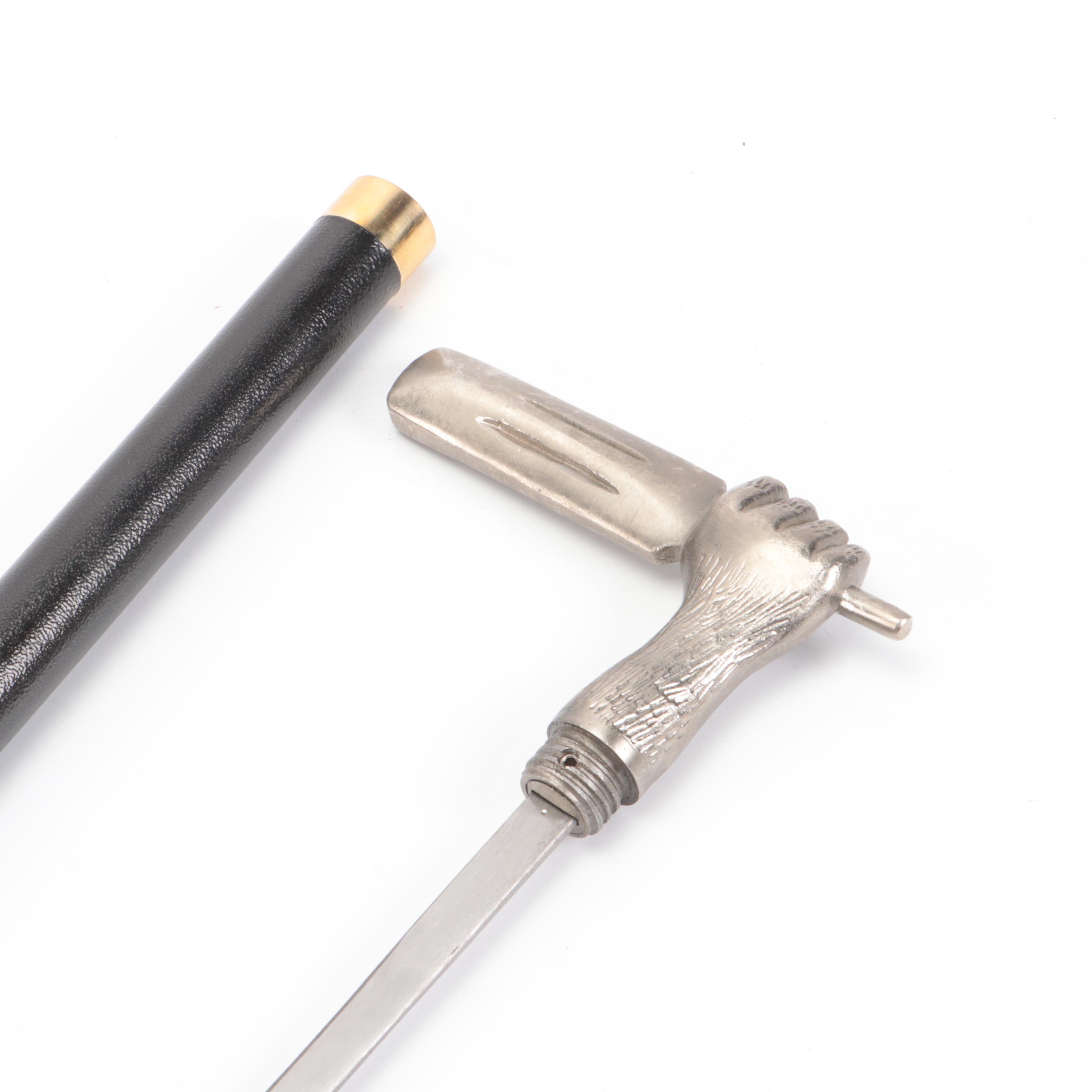 Hand Holding Paddle Handled Sword Cane