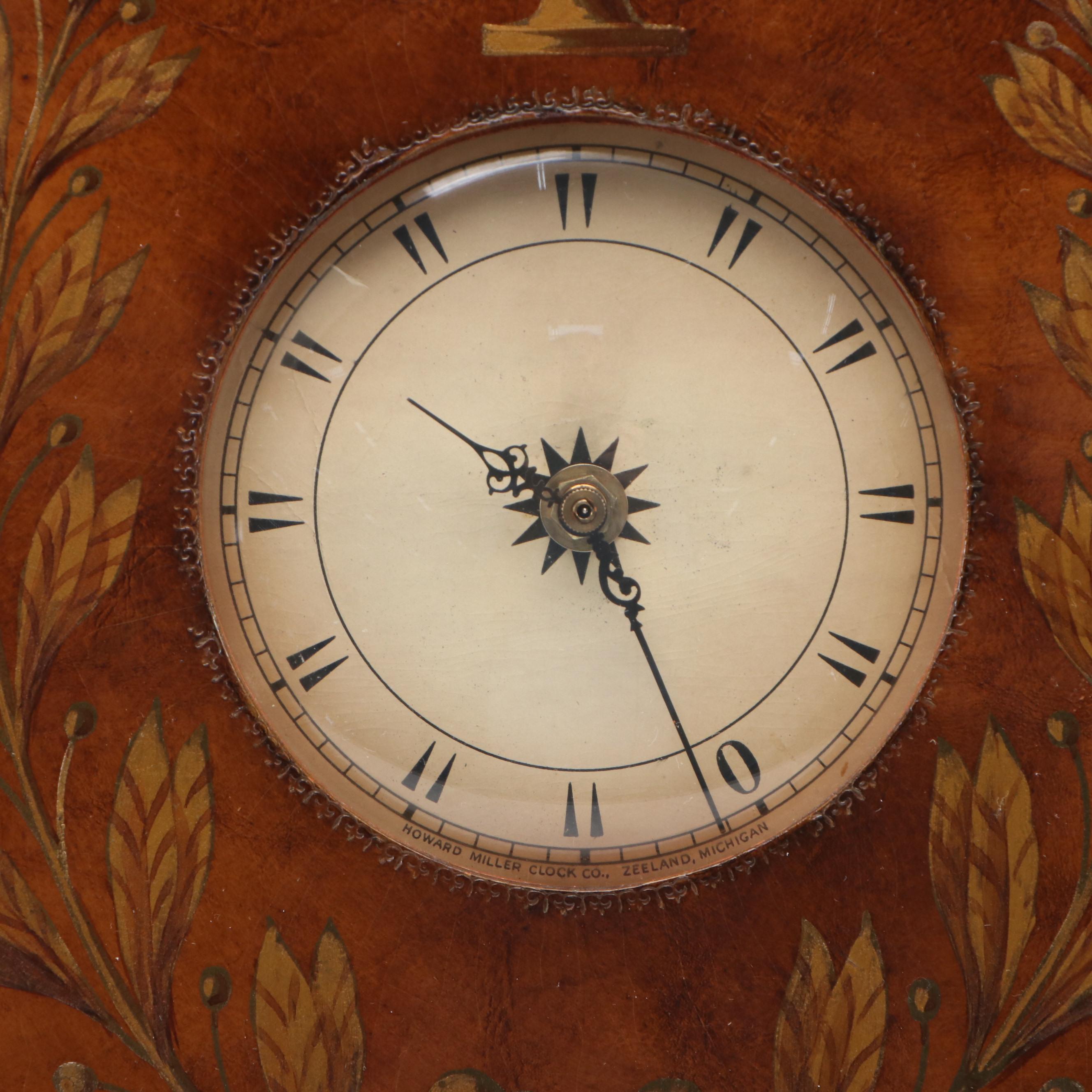 Howard Miller Laurel Motif Gilt Leather Wrapped Oval Wall Clock