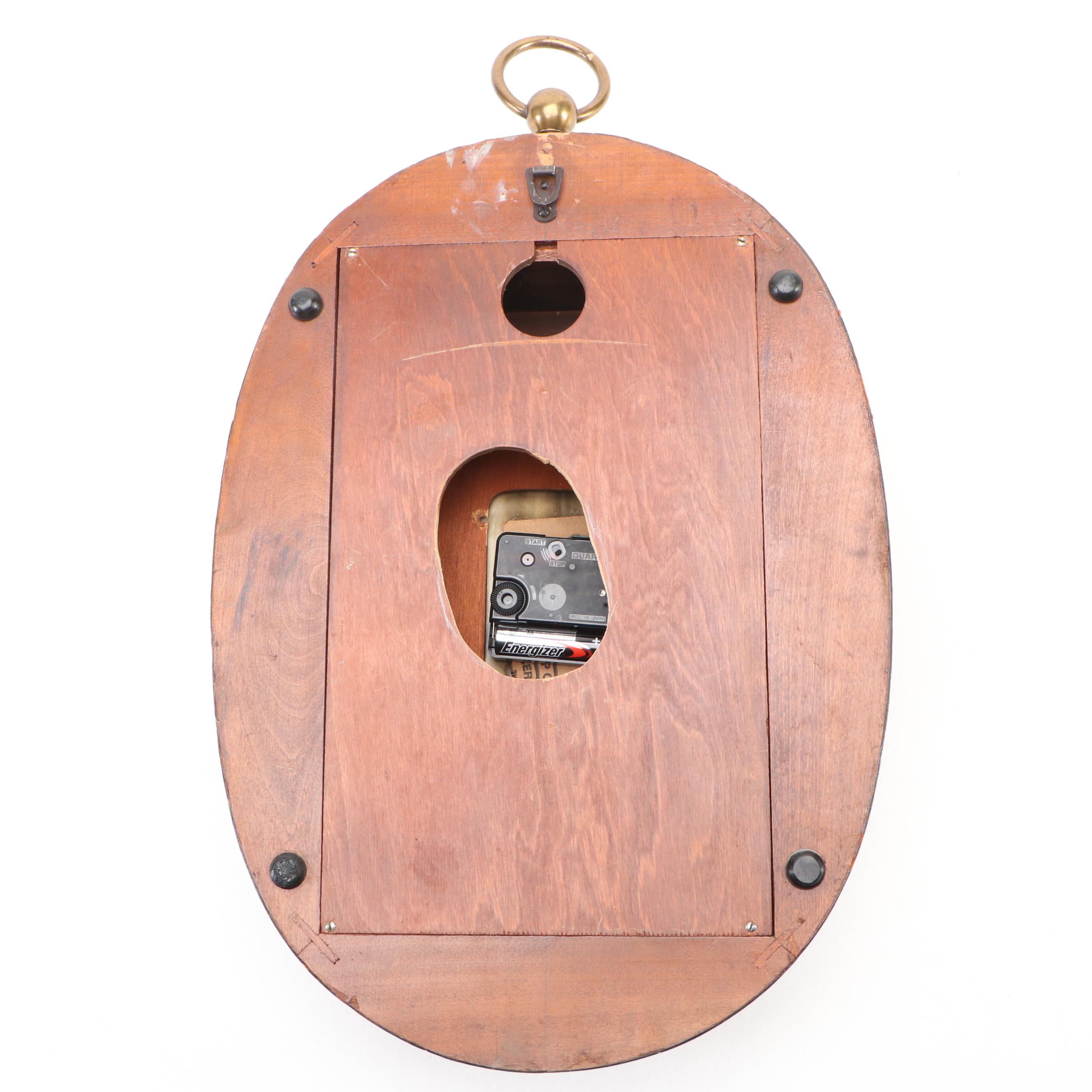 Howard Miller Laurel Motif Gilt Leather Wrapped Oval Wall Clock