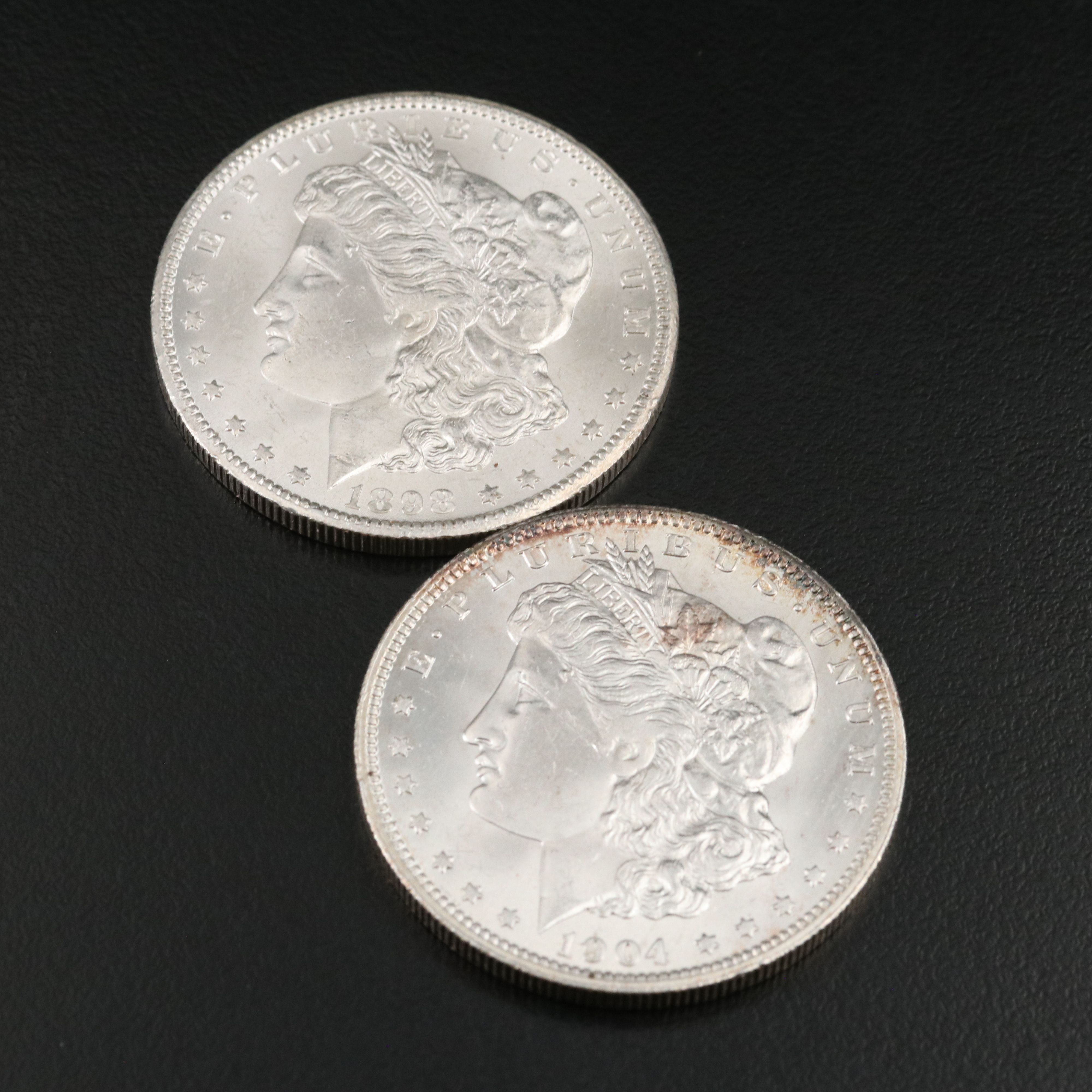 Two Morgan Silver Dollars an 1898-O and a 1904-O