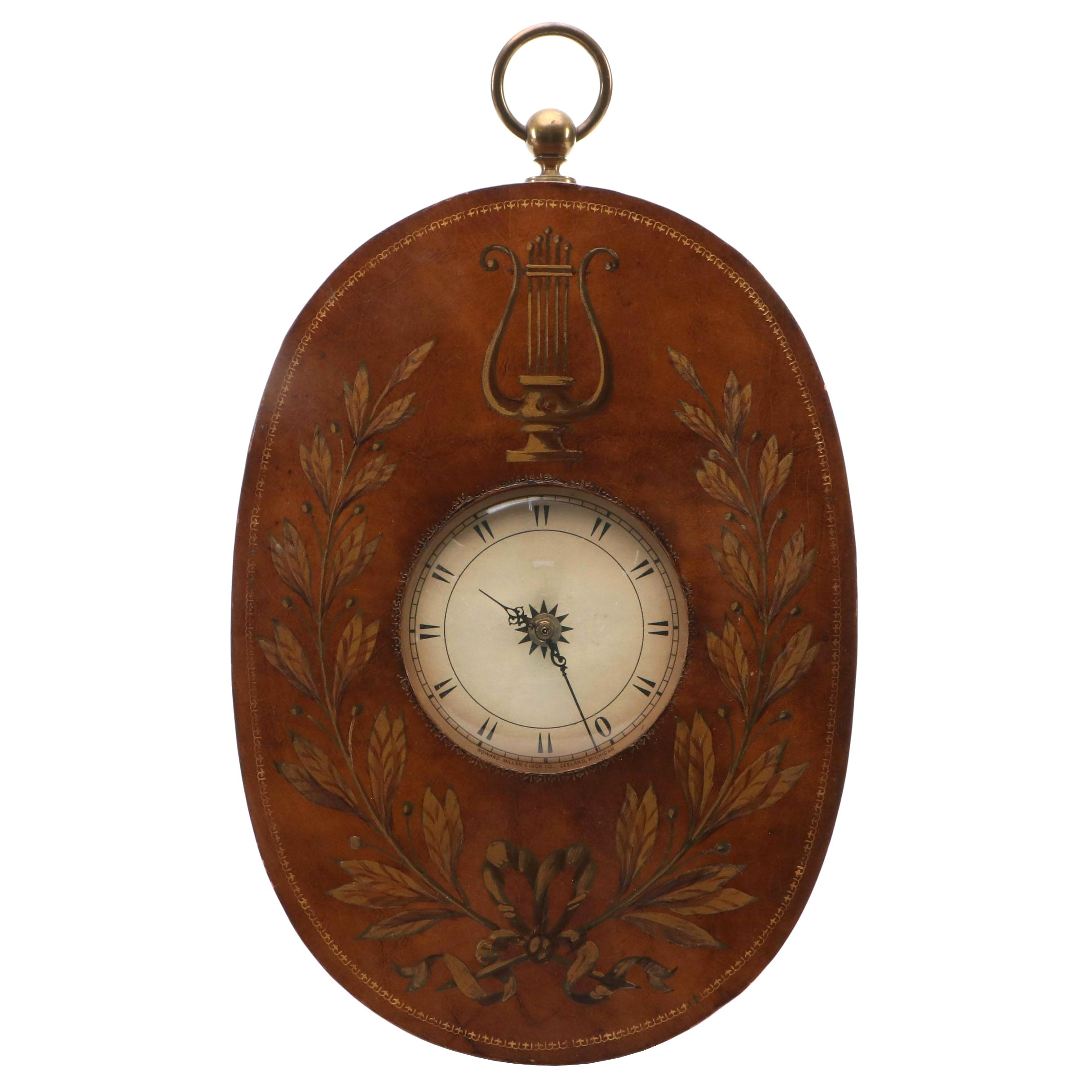 Howard Miller Laurel Motif Gilt Leather Wrapped Oval Wall Clock