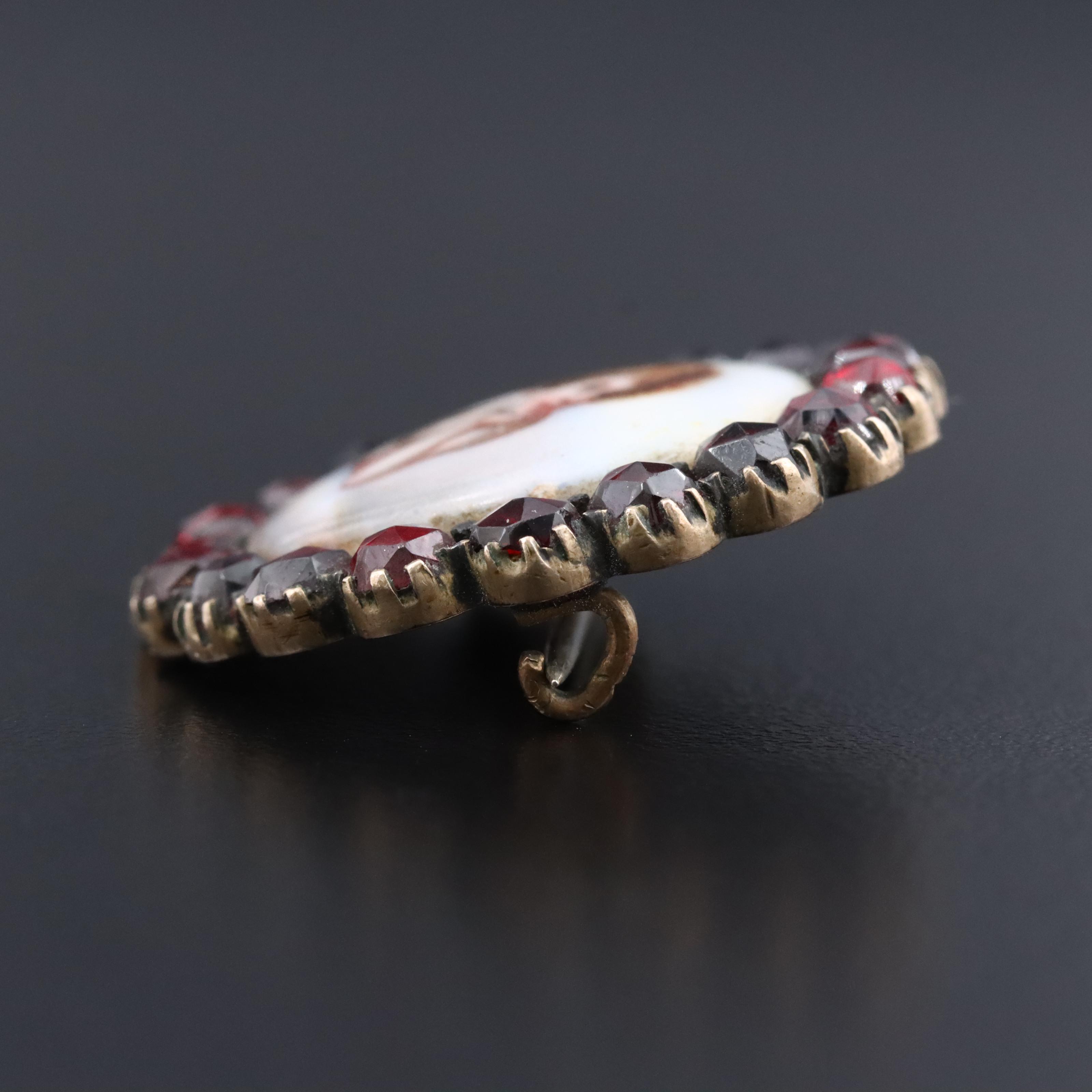 Antique Garnet and Ceramic Cherub Brooch