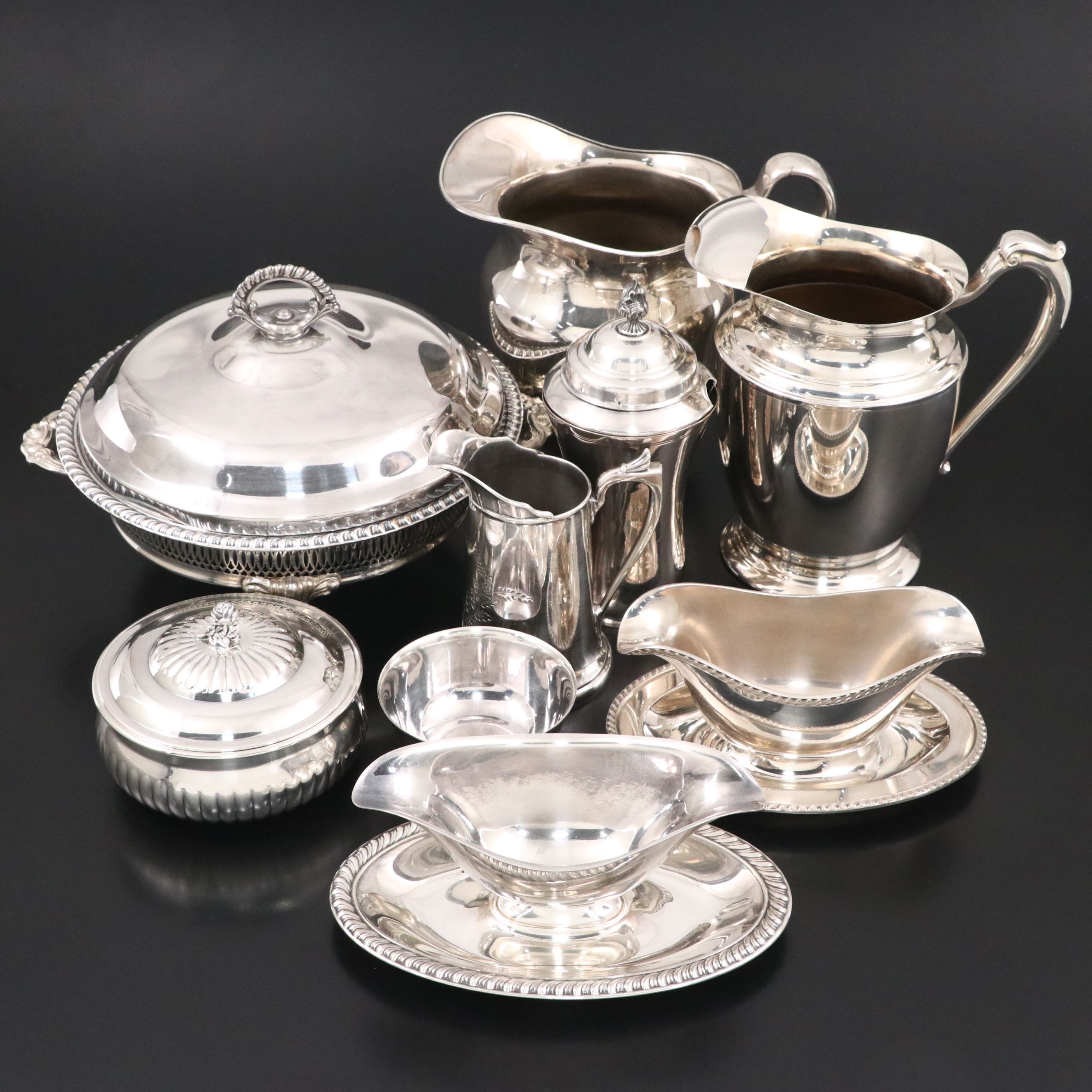 Crescent with Other Silver Plate Water Pitchers and Serving Pieces