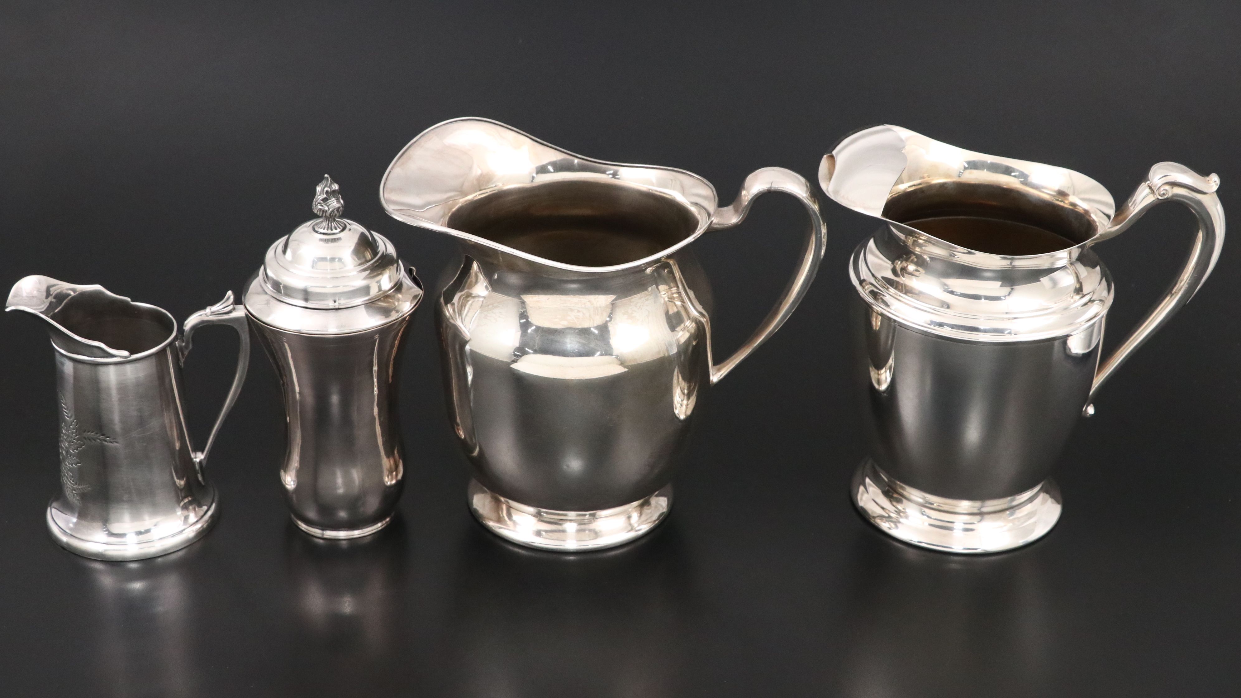 Crescent with Other Silver Plate Water Pitchers and Serving Pieces
