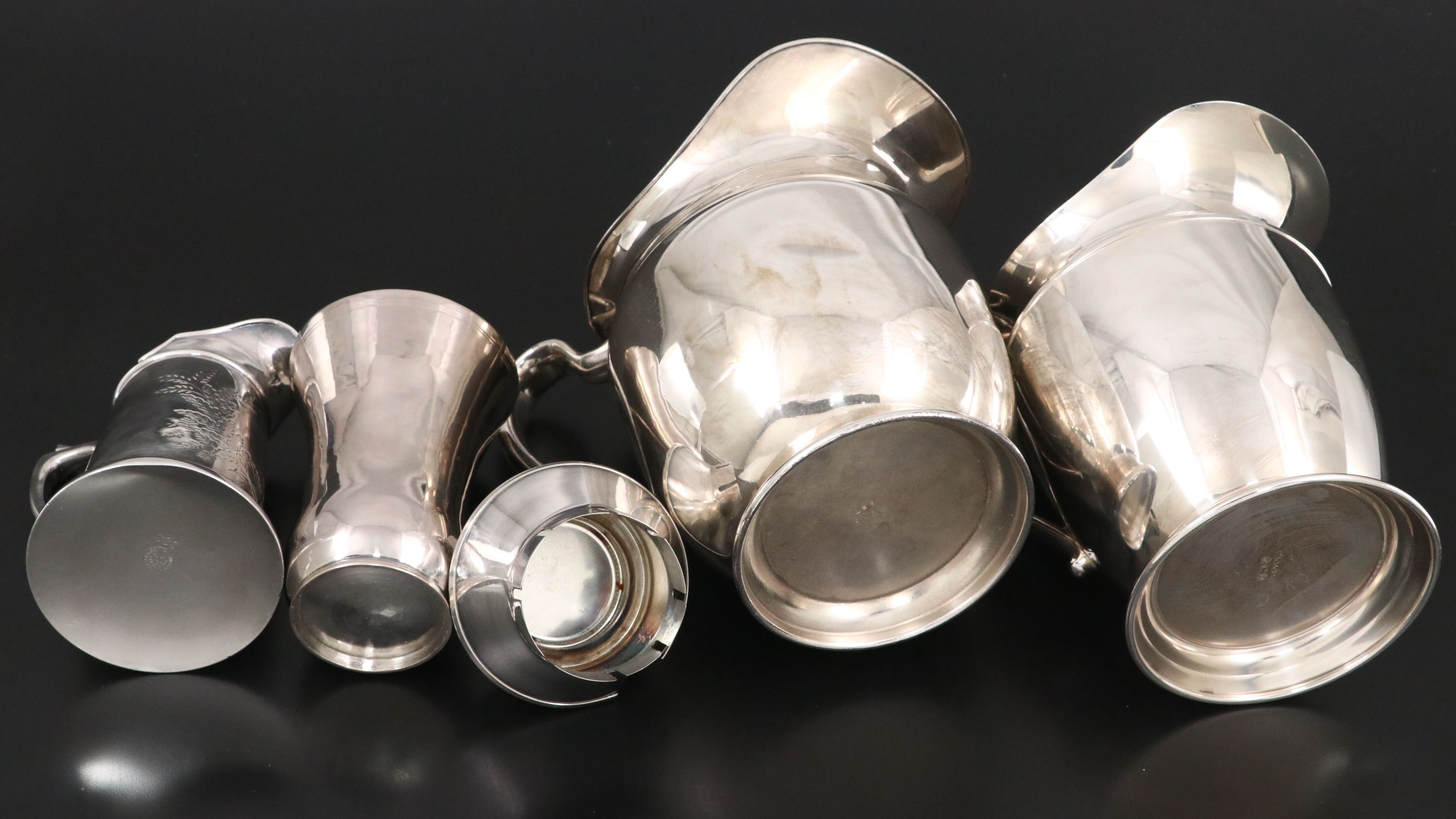 Crescent with Other Silver Plate Water Pitchers and Serving Pieces