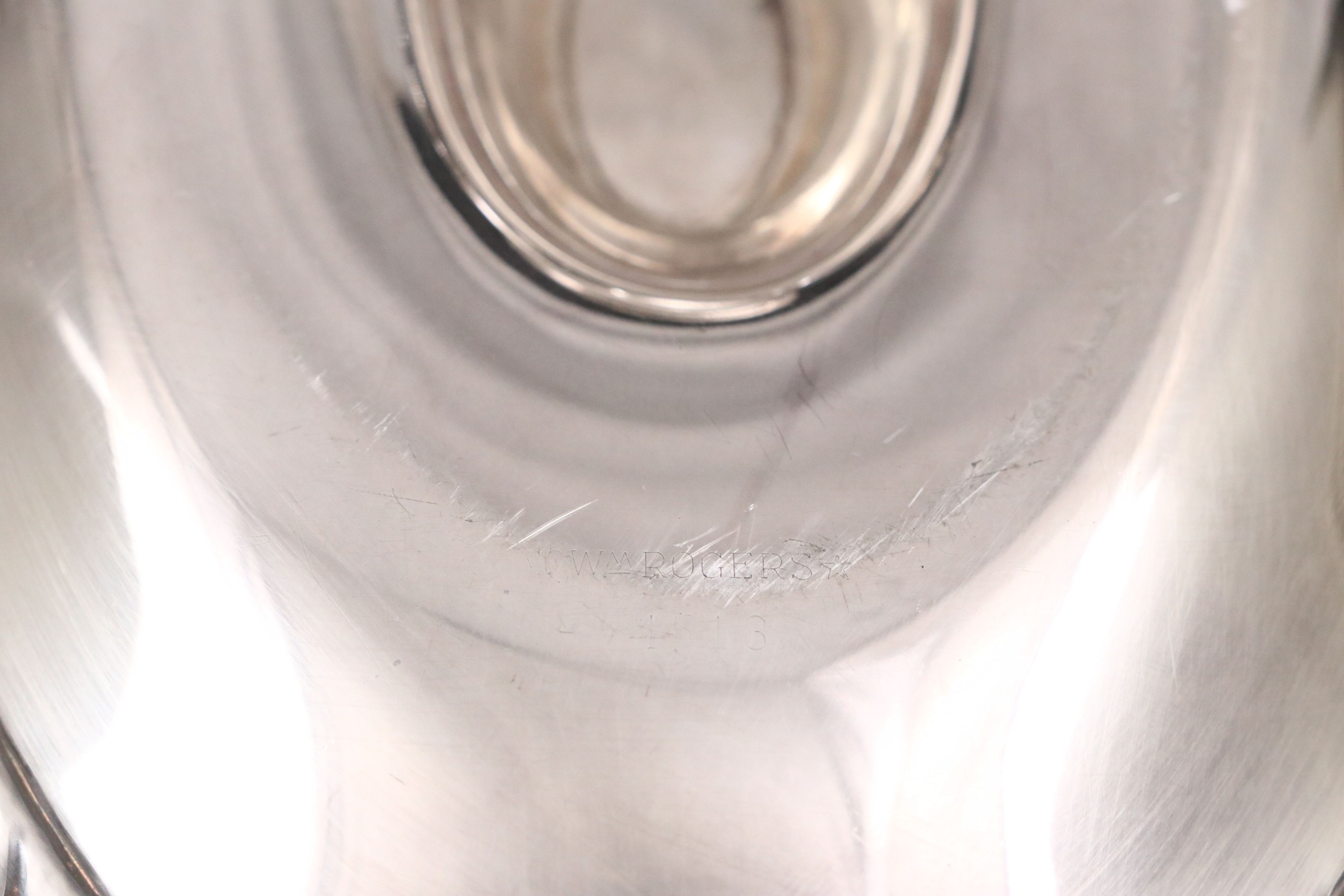 Crescent with Other Silver Plate Water Pitchers and Serving Pieces