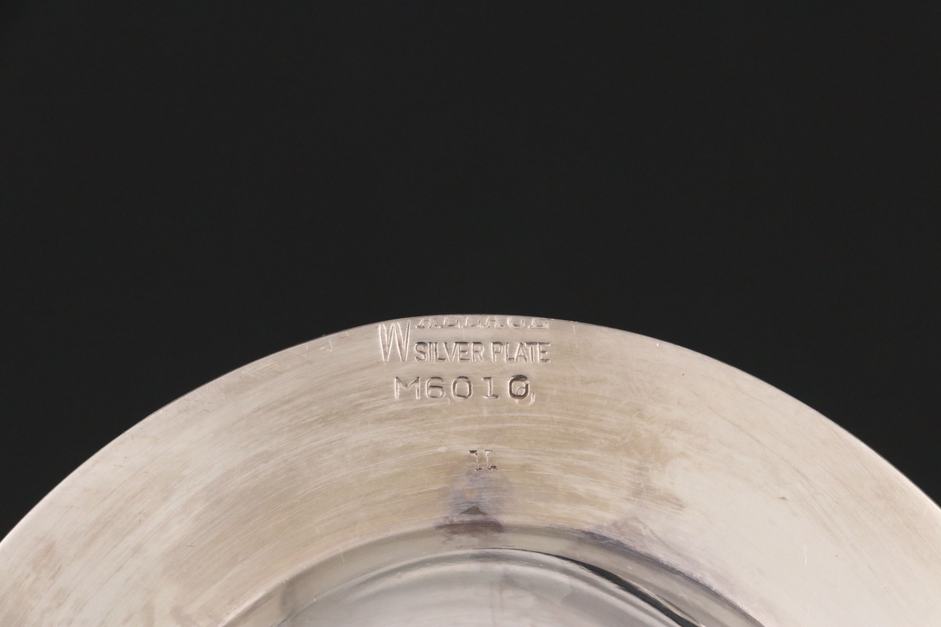 Crescent with Other Silver Plate Water Pitchers and Serving Pieces