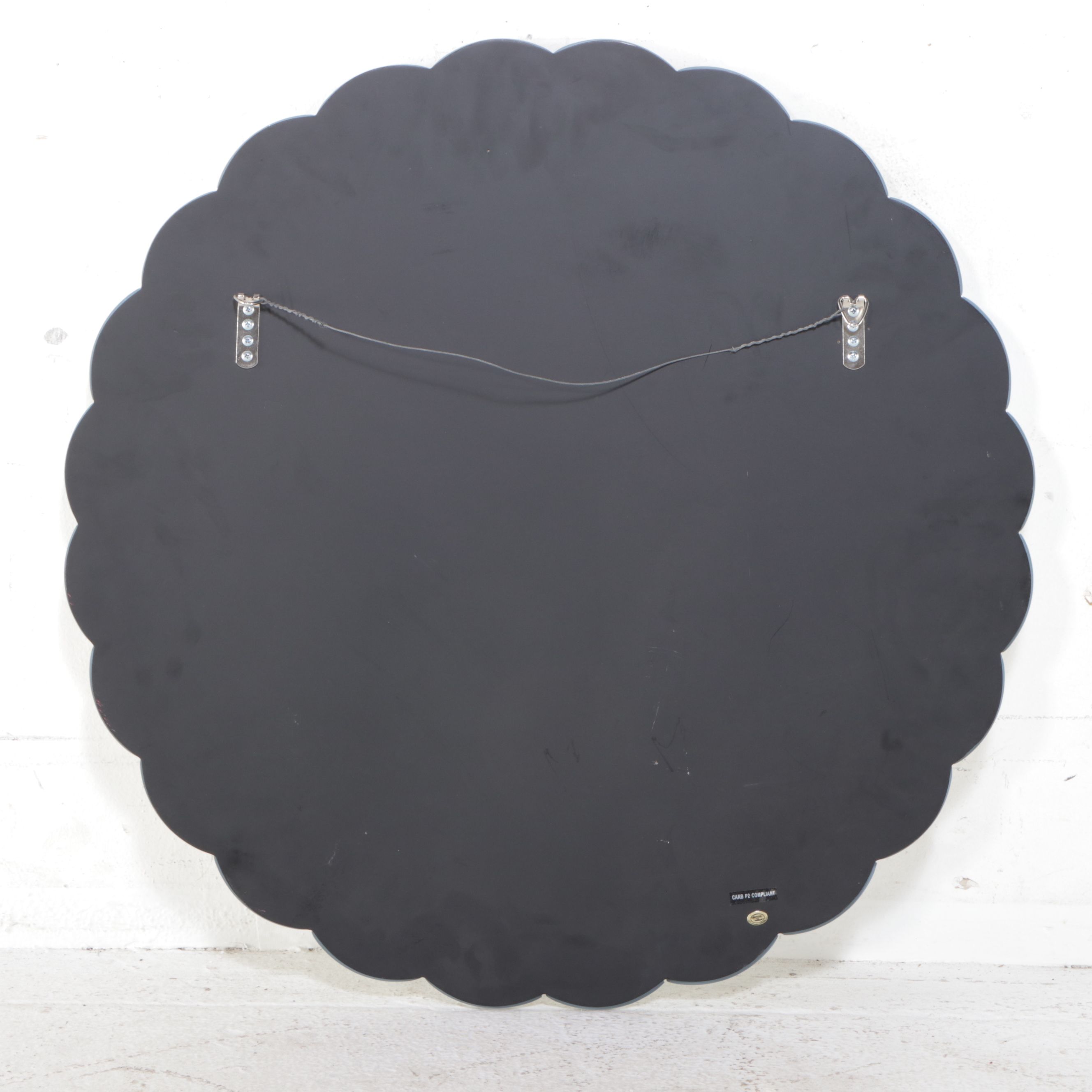 Modern Scalloped Wall Mirror with Floor Lamp and Mirrored Accent Table