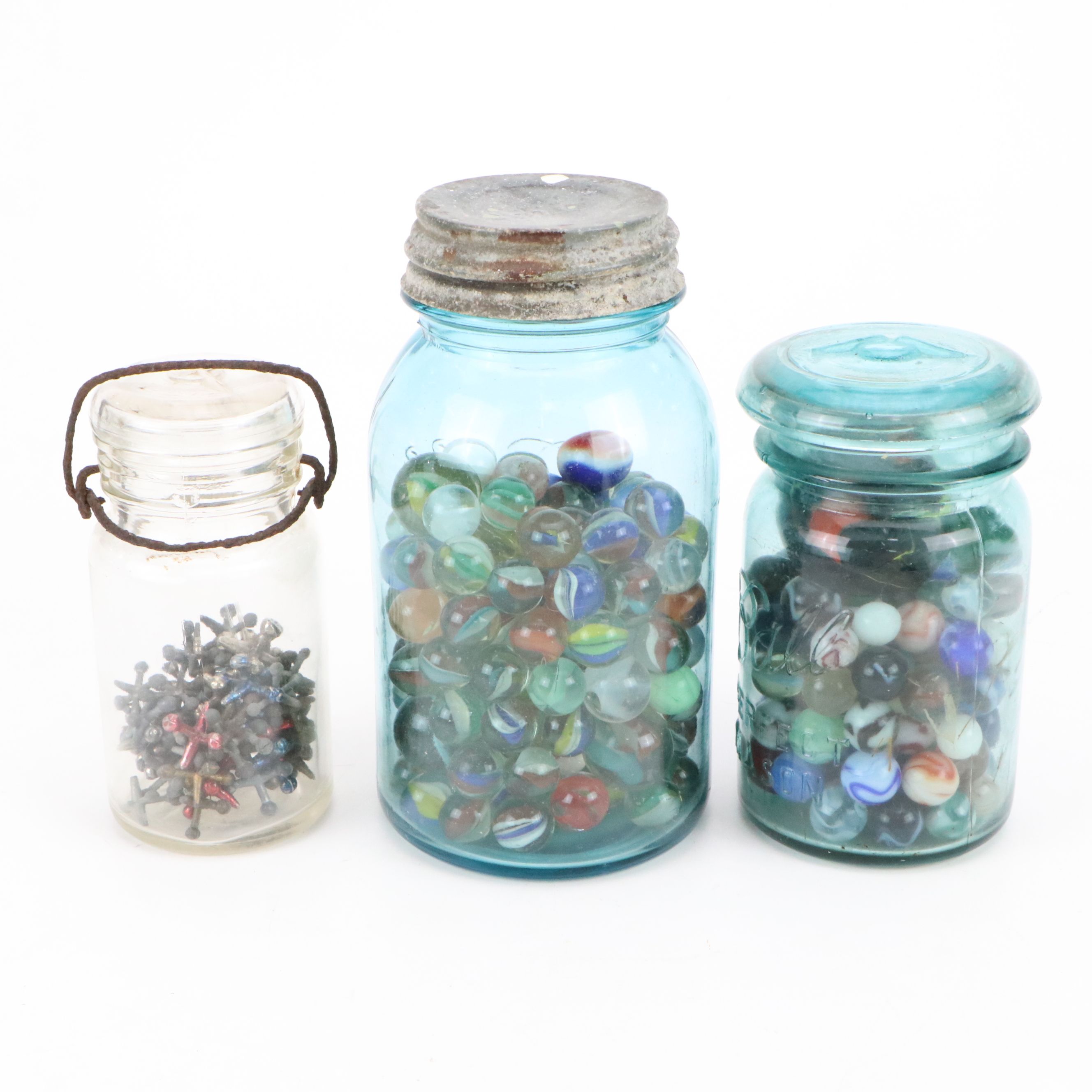 Cat's Eye, Shooters and Other Marbles in Ball Jars with Other Bottle of Jacks