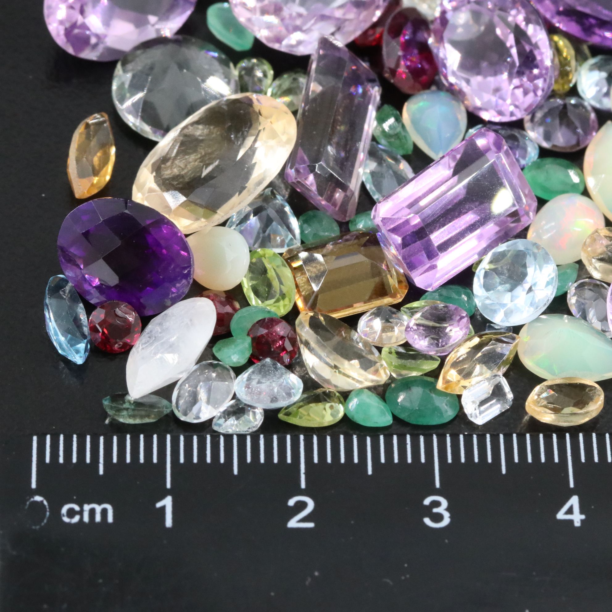 Loose 101.48 CTW Gemstone Lot Including Amethyst, Garnet and Emerald
