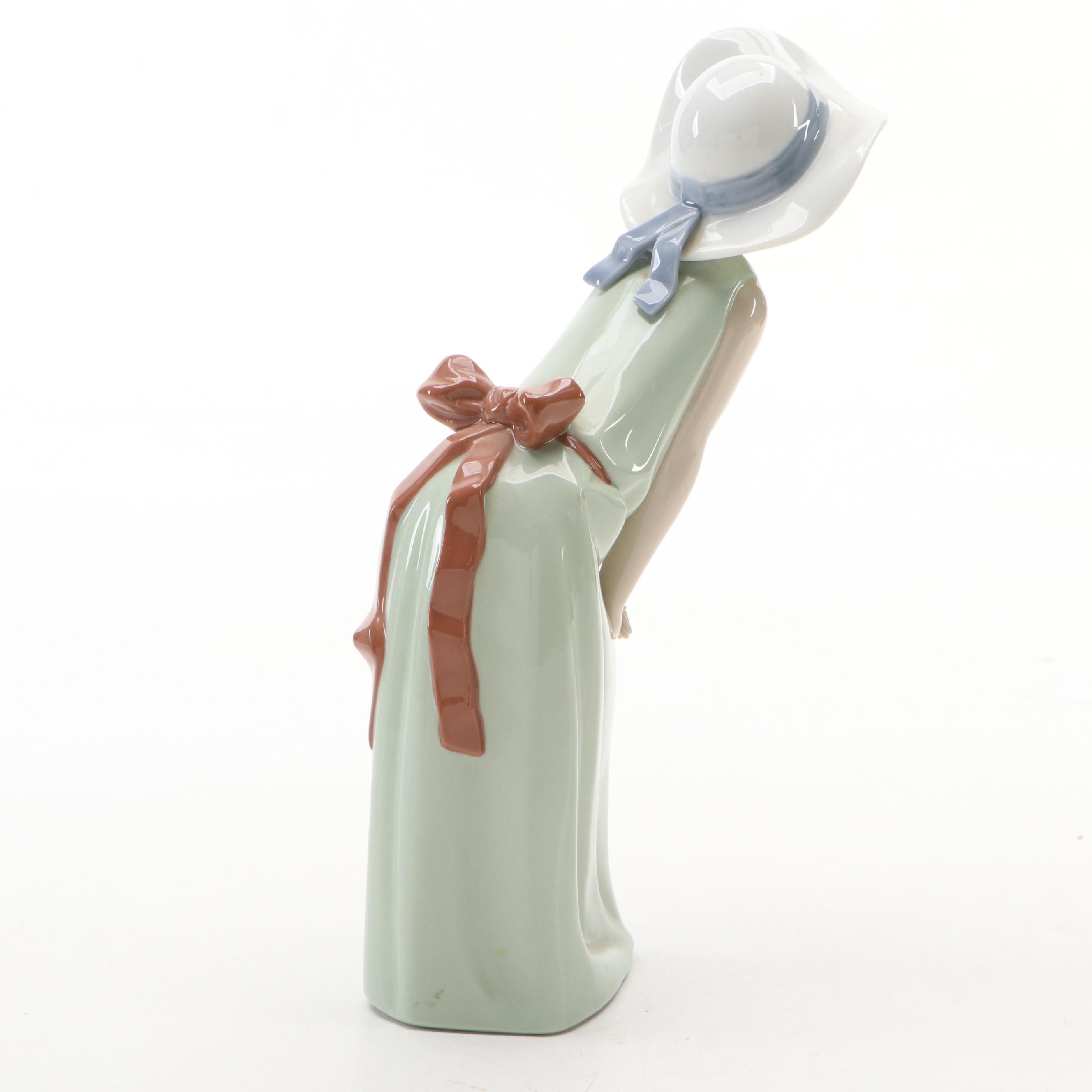 Lladró "Curious Girl with Straw Hat" Porcelain Figurine