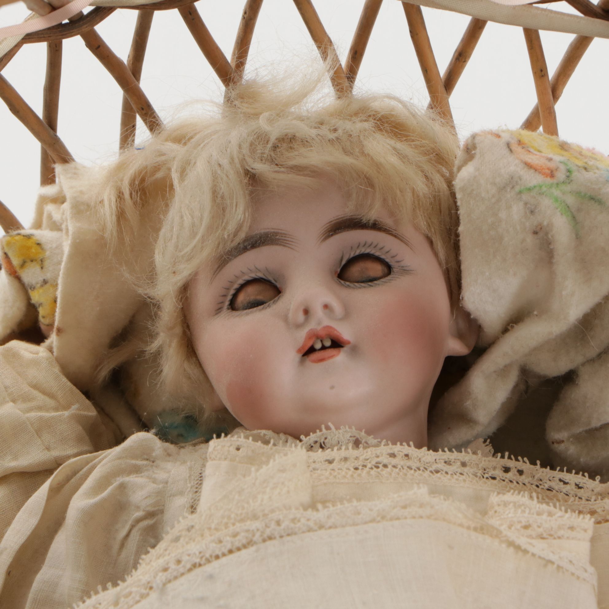 German Porcelain Open Mouth Doll with Composition Body and Wicker Cradle