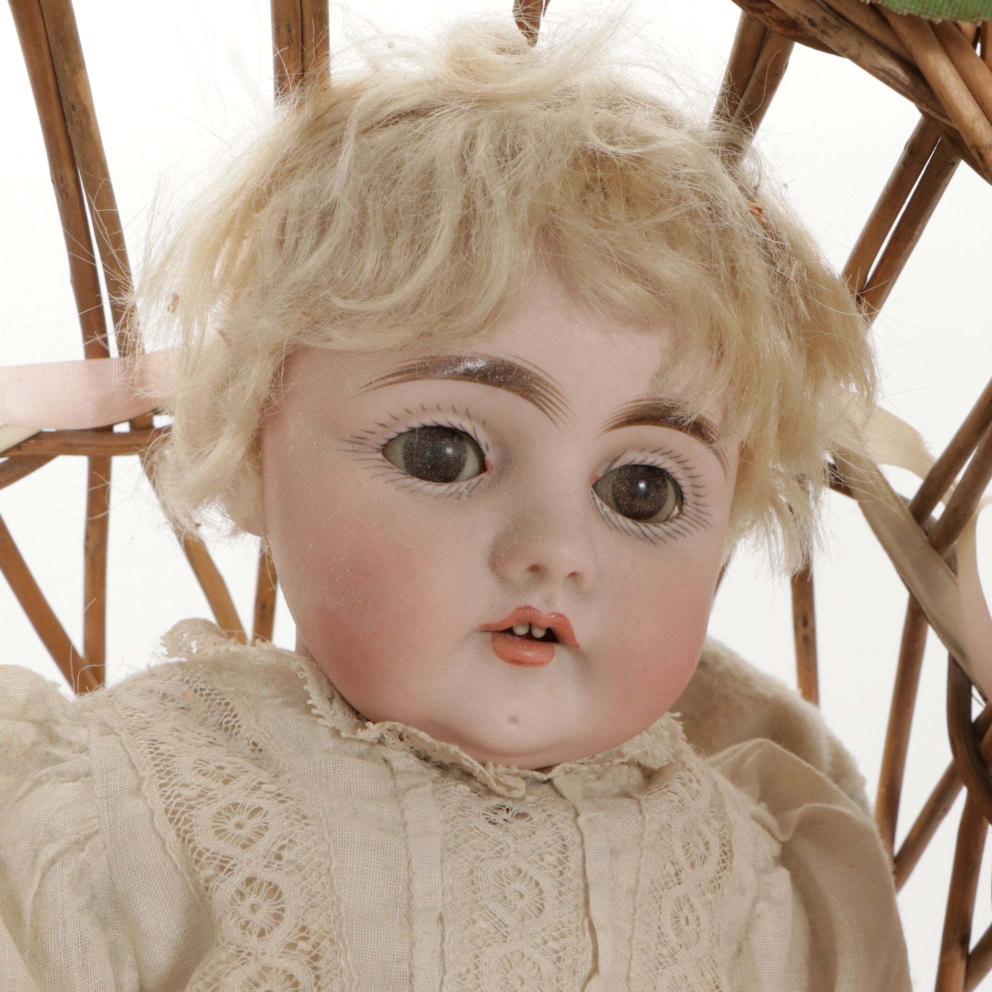 German Porcelain Open Mouth Doll with Composition Body and Wicker Cradle