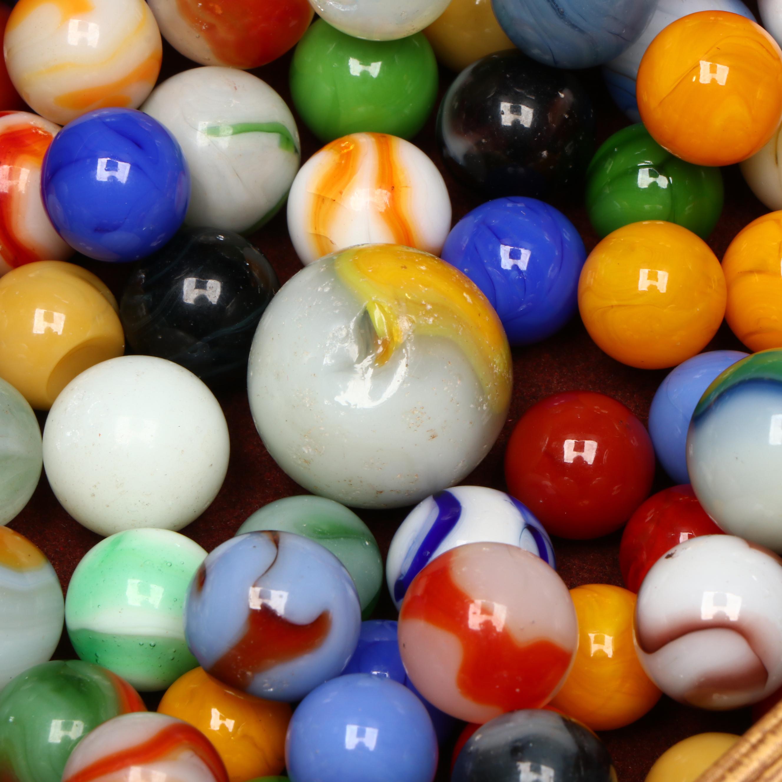 Swirlies, Shooters and Other Marbles in Decorative Boxes.