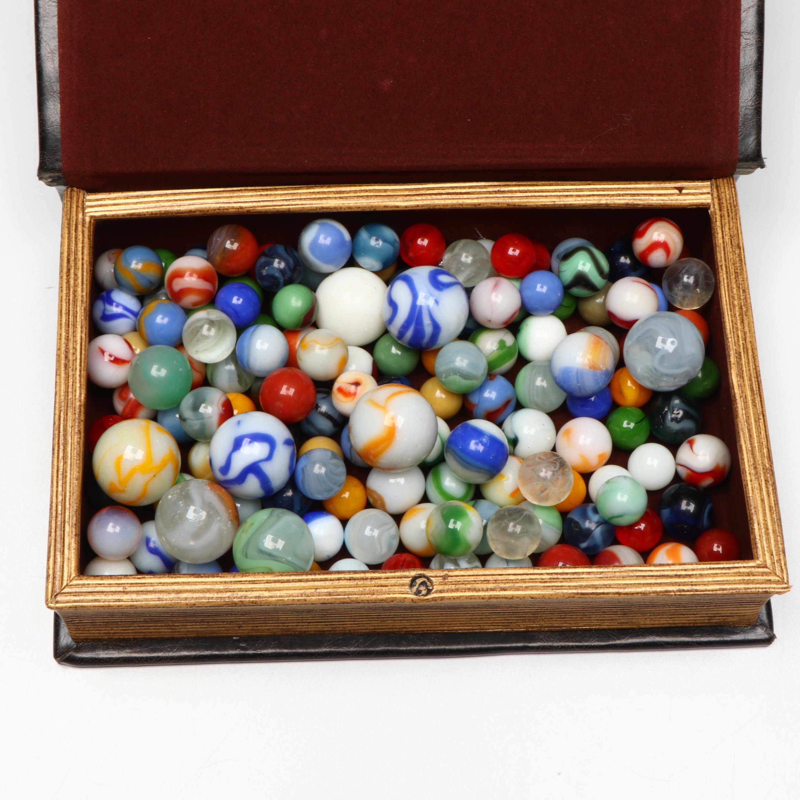 Swirlies, Shooters and Other Marbles in Decorative Boxes.