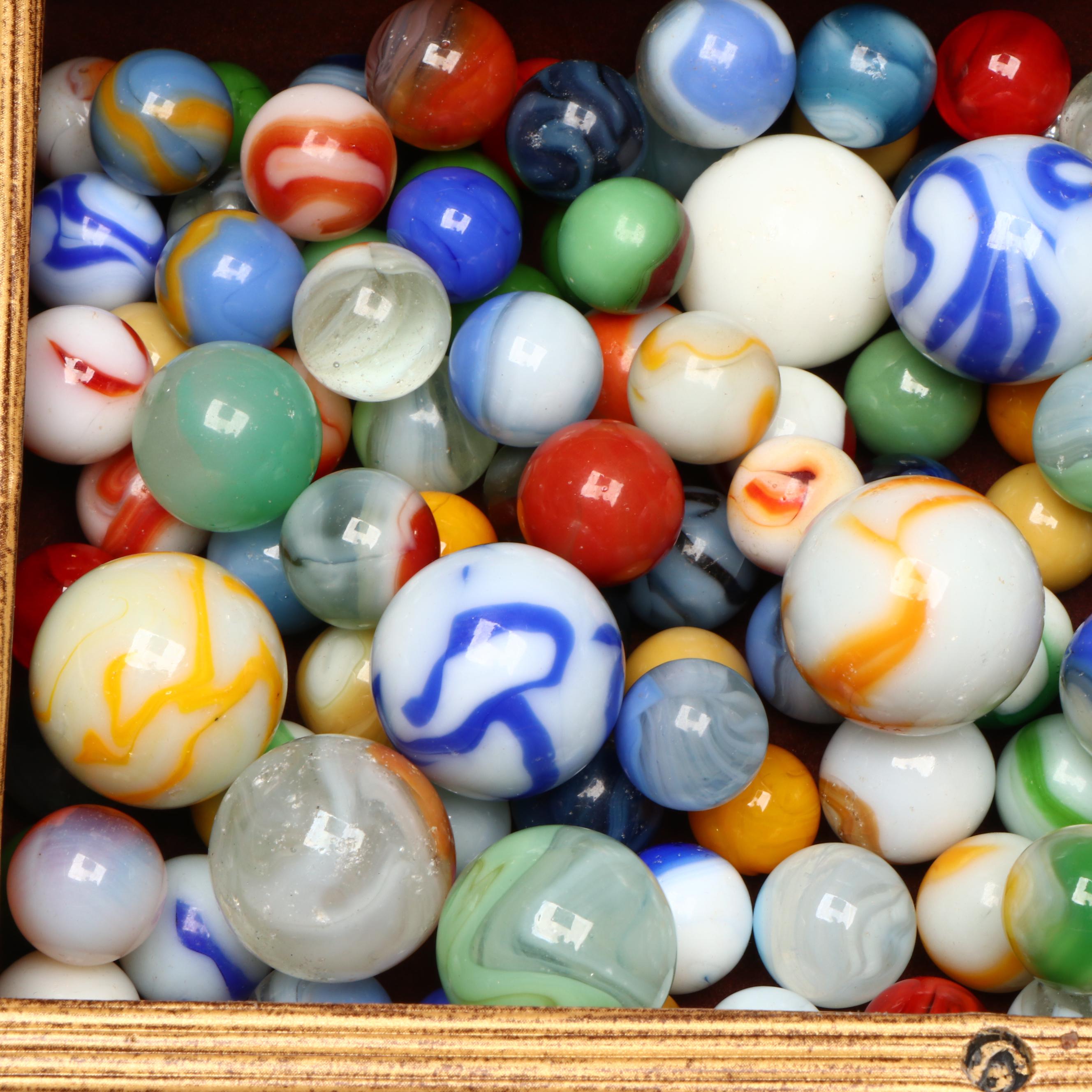 Swirlies, Shooters and Other Marbles in Decorative Boxes.