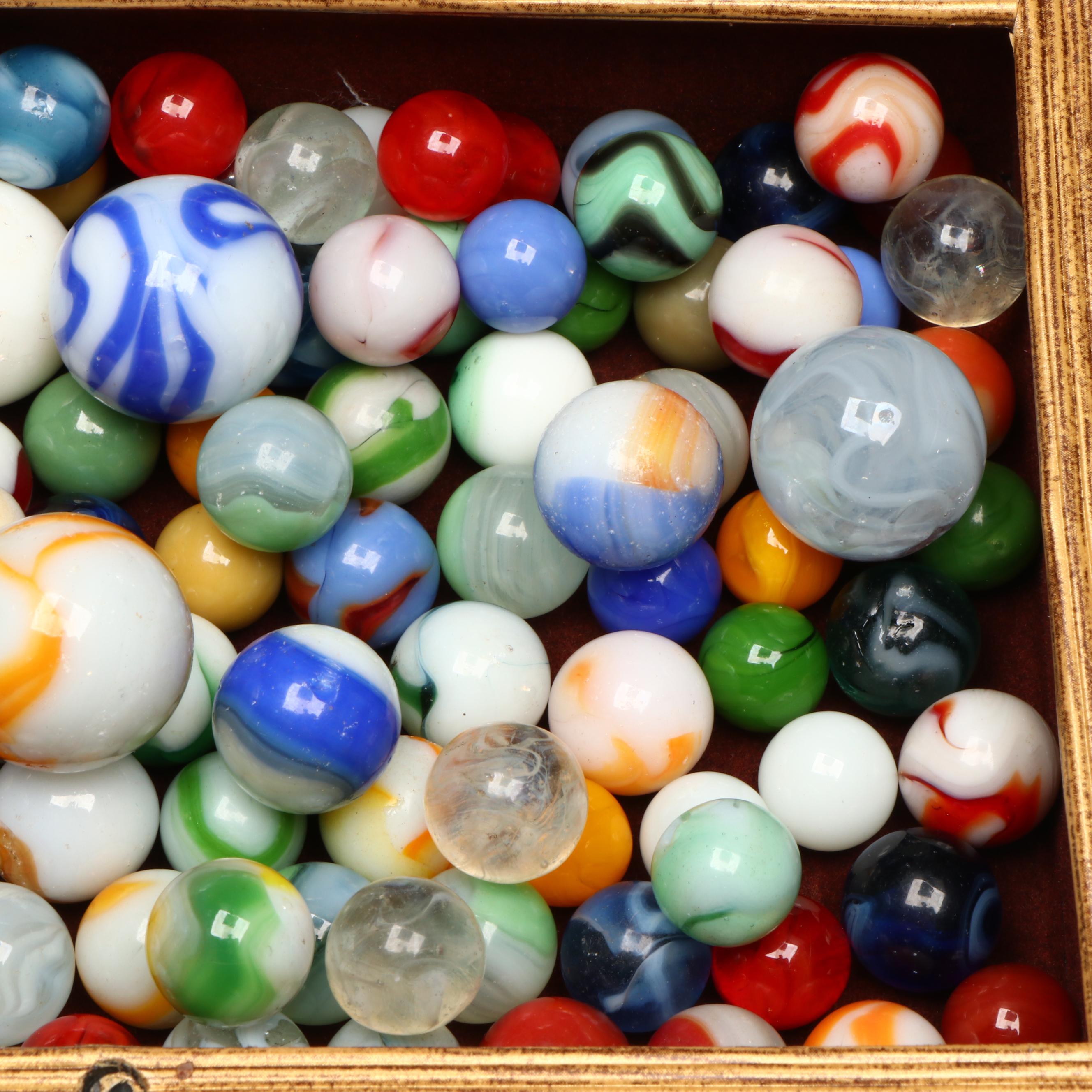 Swirlies, Shooters and Other Marbles in Decorative Boxes.