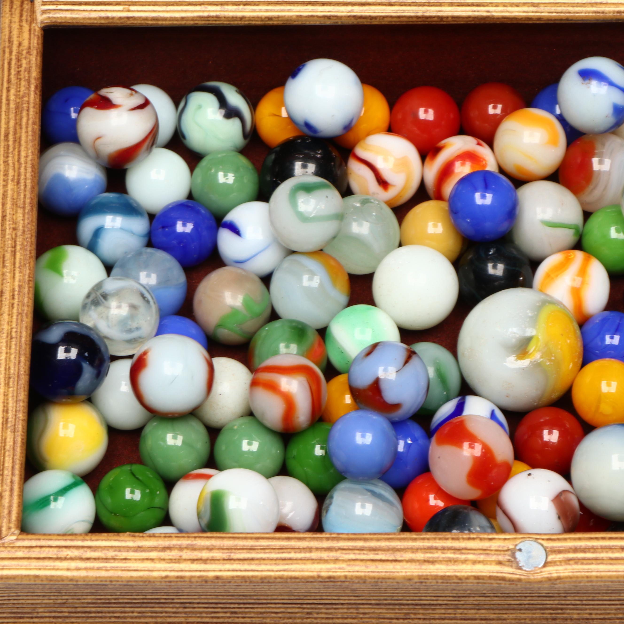 Swirlies, Shooters and Other Marbles in Decorative Boxes.