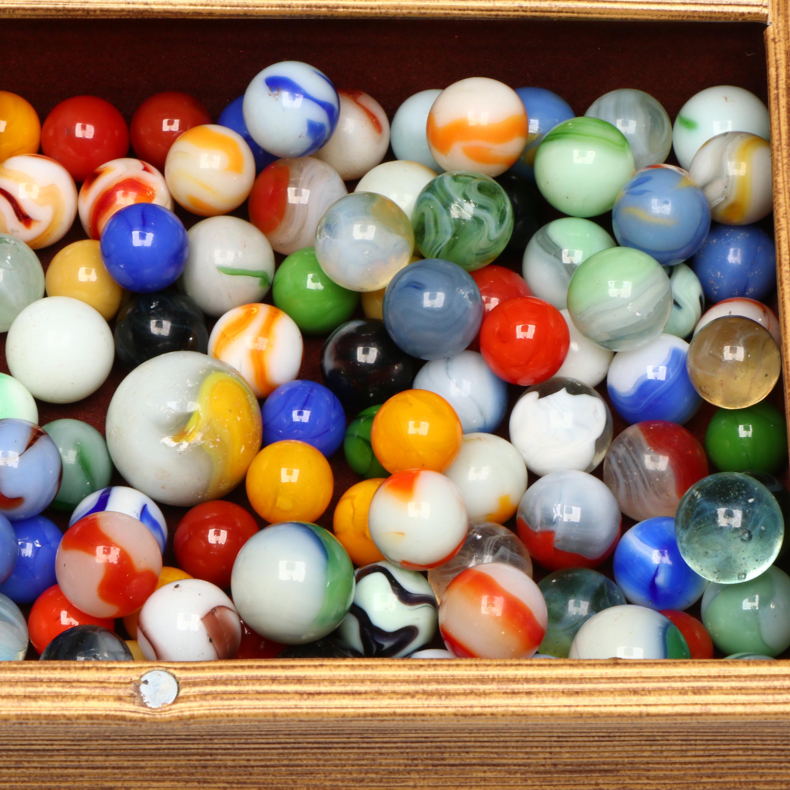 Swirlies, Shooters and Other Marbles in Decorative Boxes.
