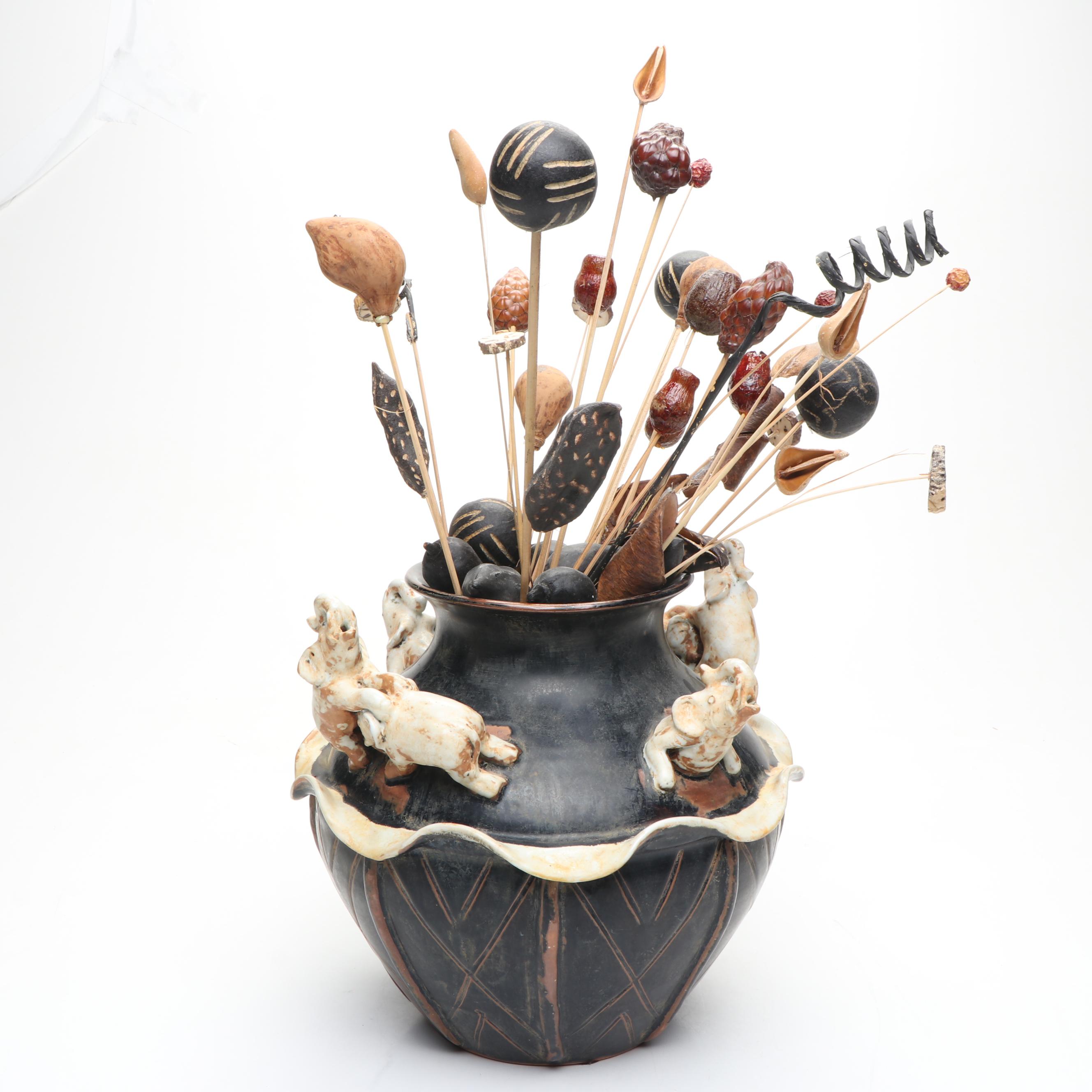 Ceramic Vase with Elephant Ornamentation and Carved Wood Seed Pod Décor