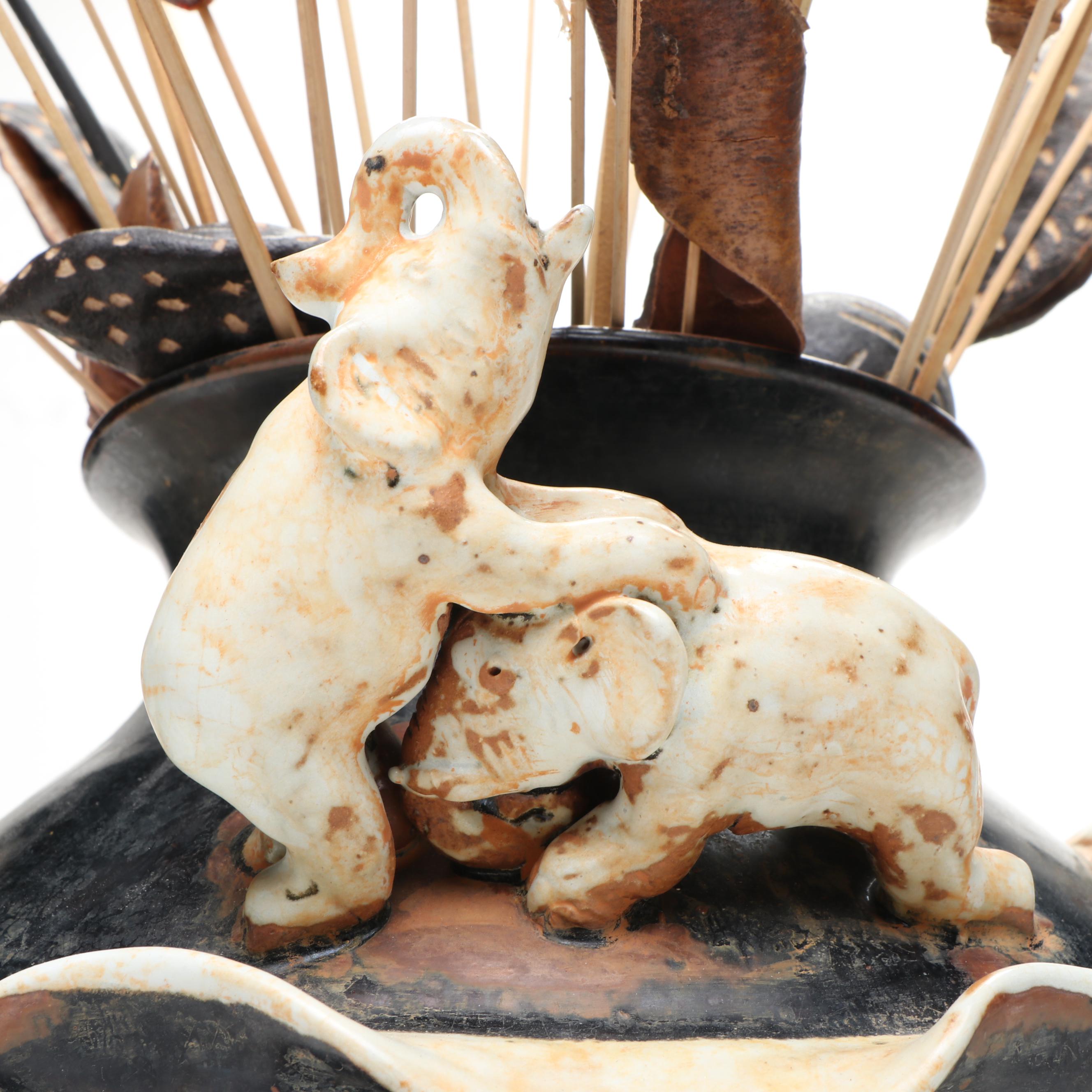 Ceramic Vase with Elephant Ornamentation and Carved Wood Seed Pod Décor