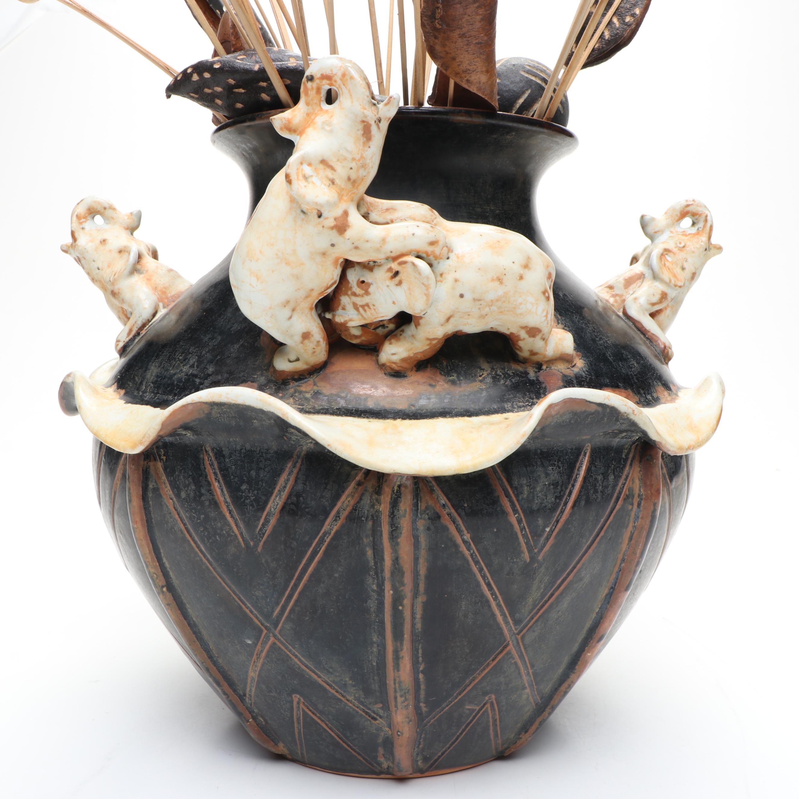 Ceramic Vase with Elephant Ornamentation and Carved Wood Seed Pod Décor