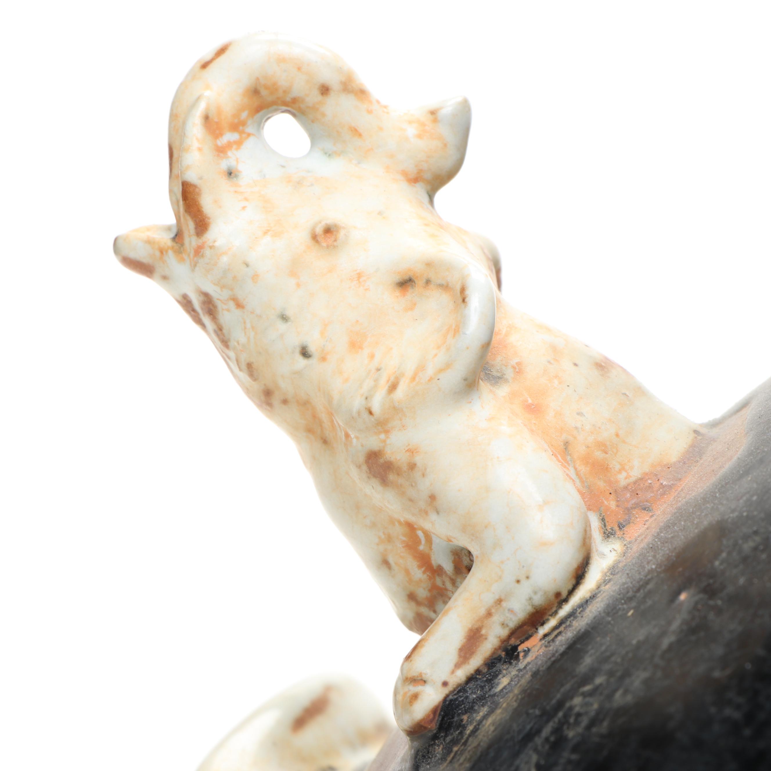 Ceramic Vase with Elephant Ornamentation and Carved Wood Seed Pod Décor