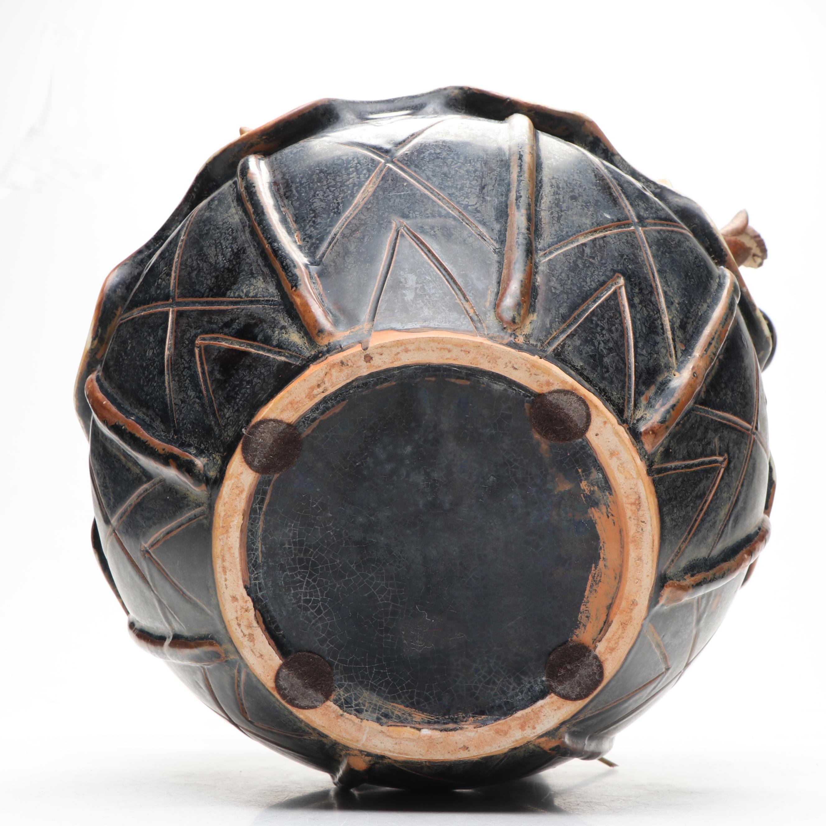 Ceramic Vase with Elephant Ornamentation and Carved Wood Seed Pod Décor