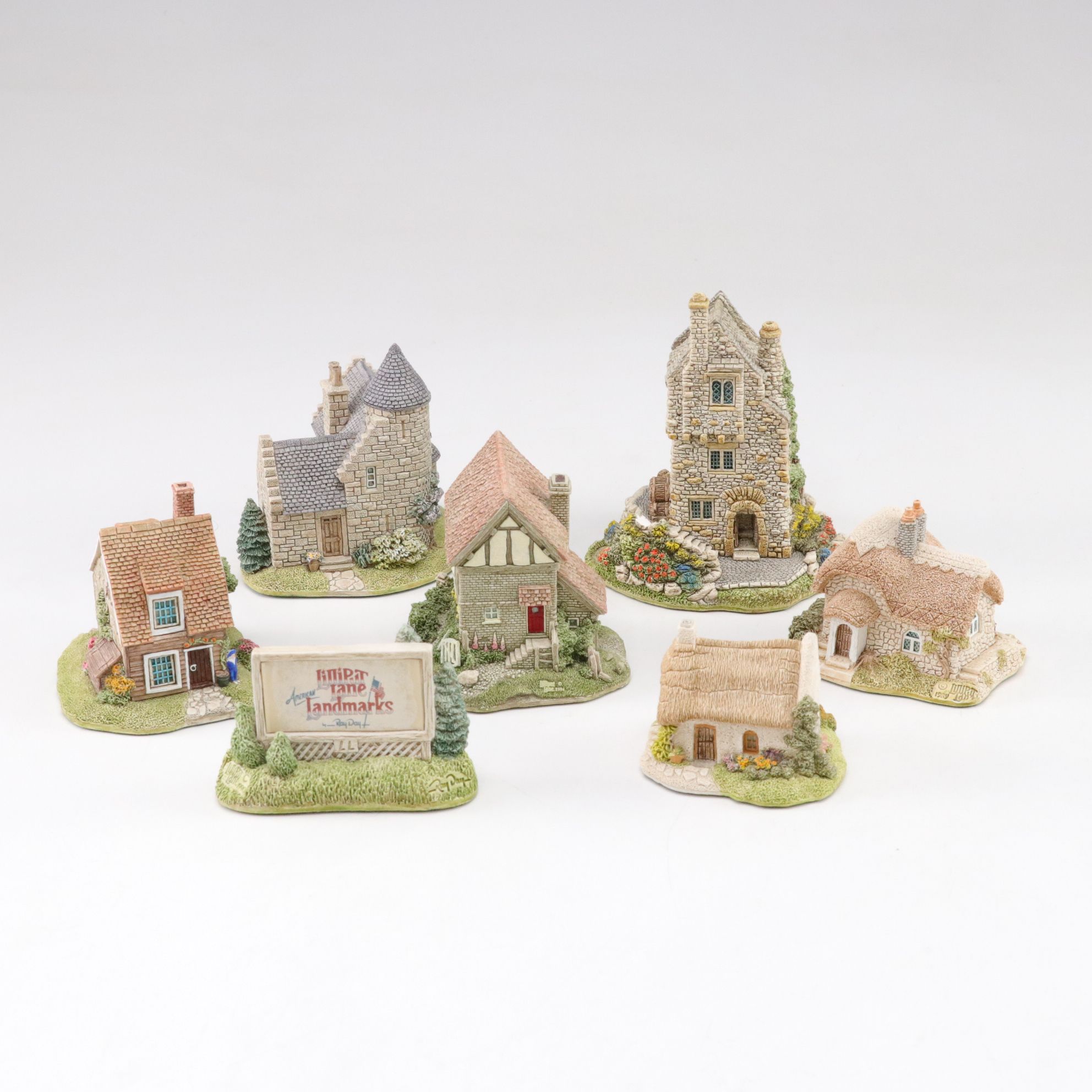 Six Lilliput Lane Buildings with "Ladybank Lodge" and "Tired Timbers" and a Sign