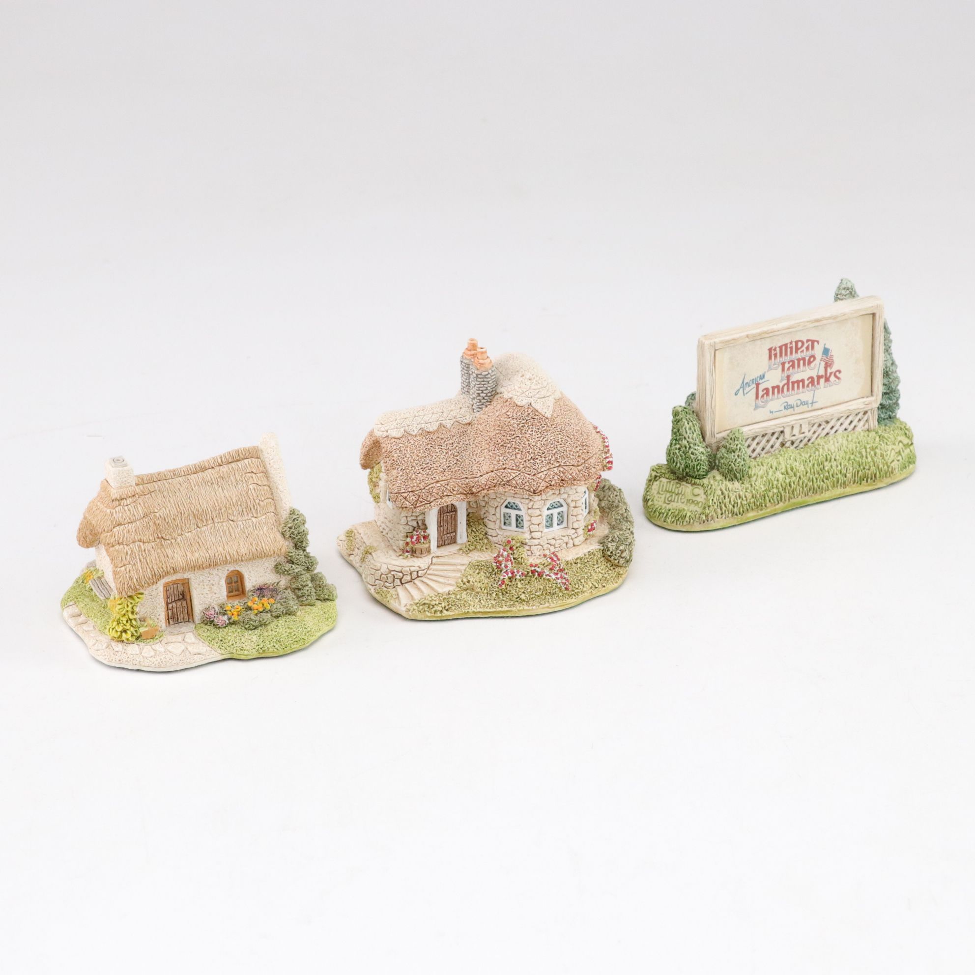 Six Lilliput Lane Buildings with "Ladybank Lodge" and "Tired Timbers" and a Sign