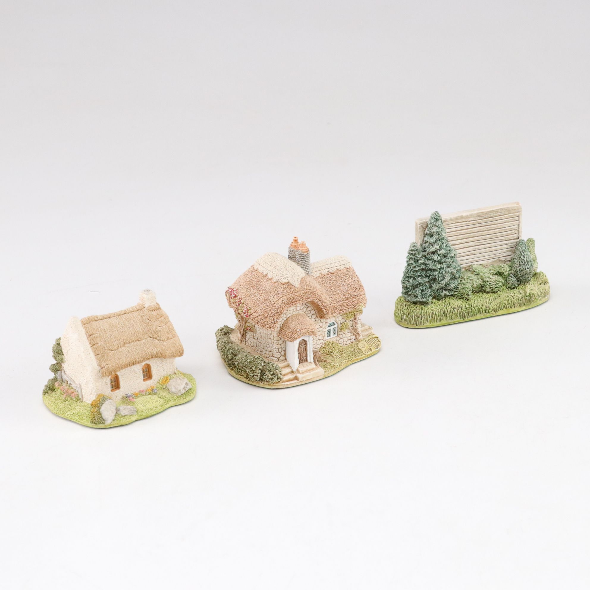 Six Lilliput Lane Buildings with "Ladybank Lodge" and "Tired Timbers" and a Sign