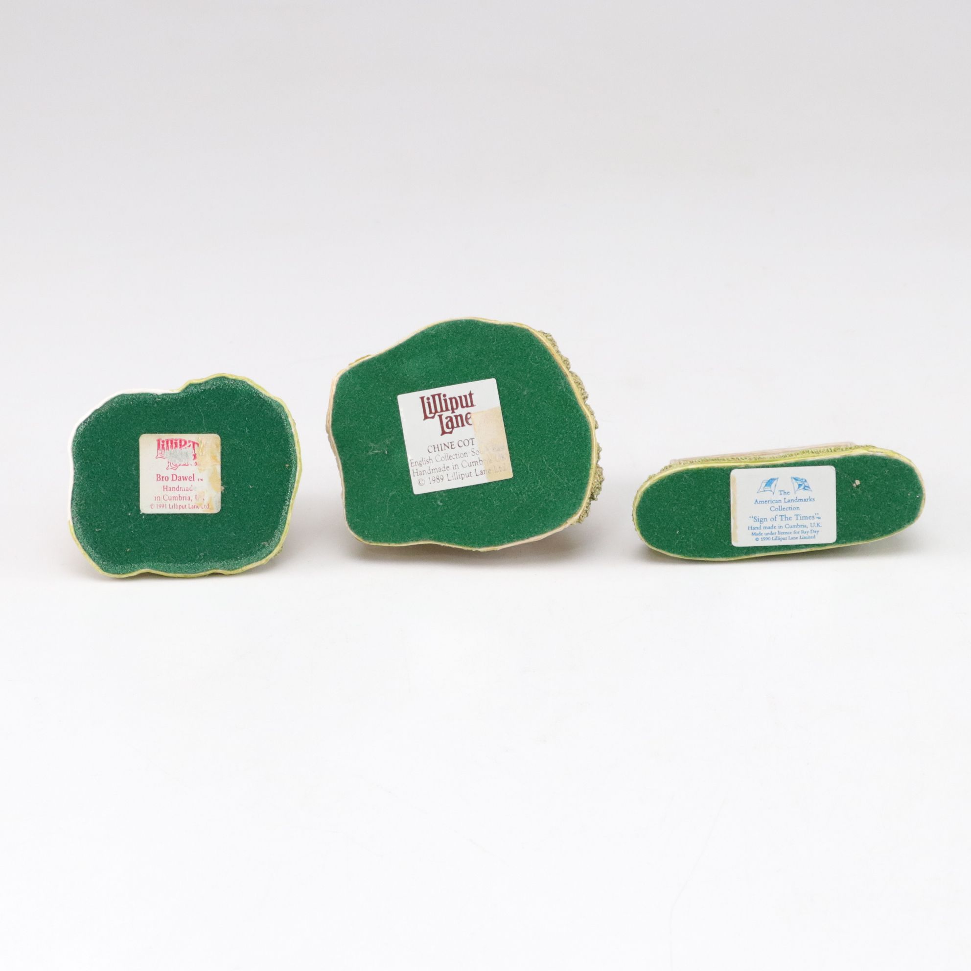 Six Lilliput Lane Buildings with "Ladybank Lodge" and "Tired Timbers" and a Sign