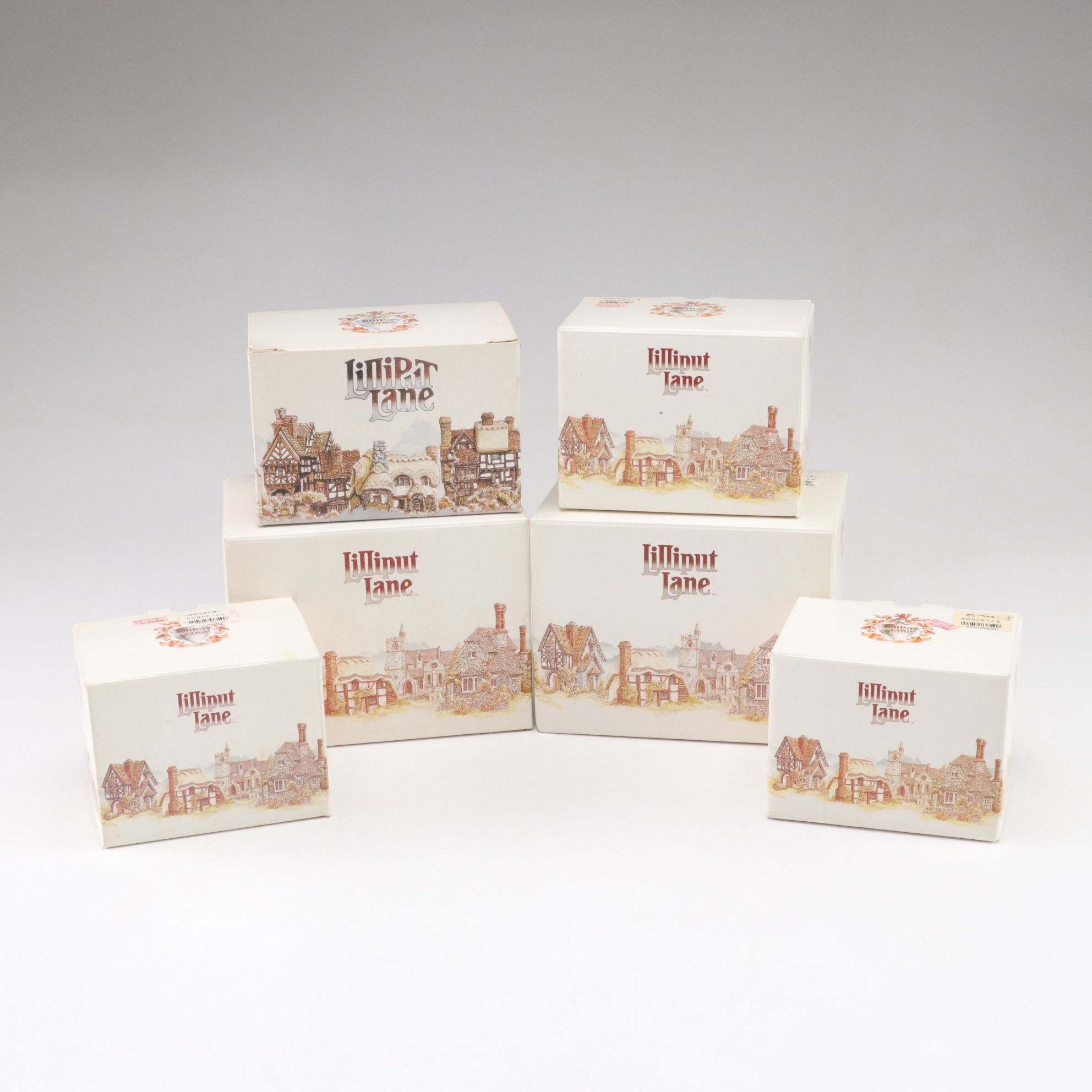 Six Lilliput Lane Buildings with "Ladybank Lodge" and "Tired Timbers" and a Sign