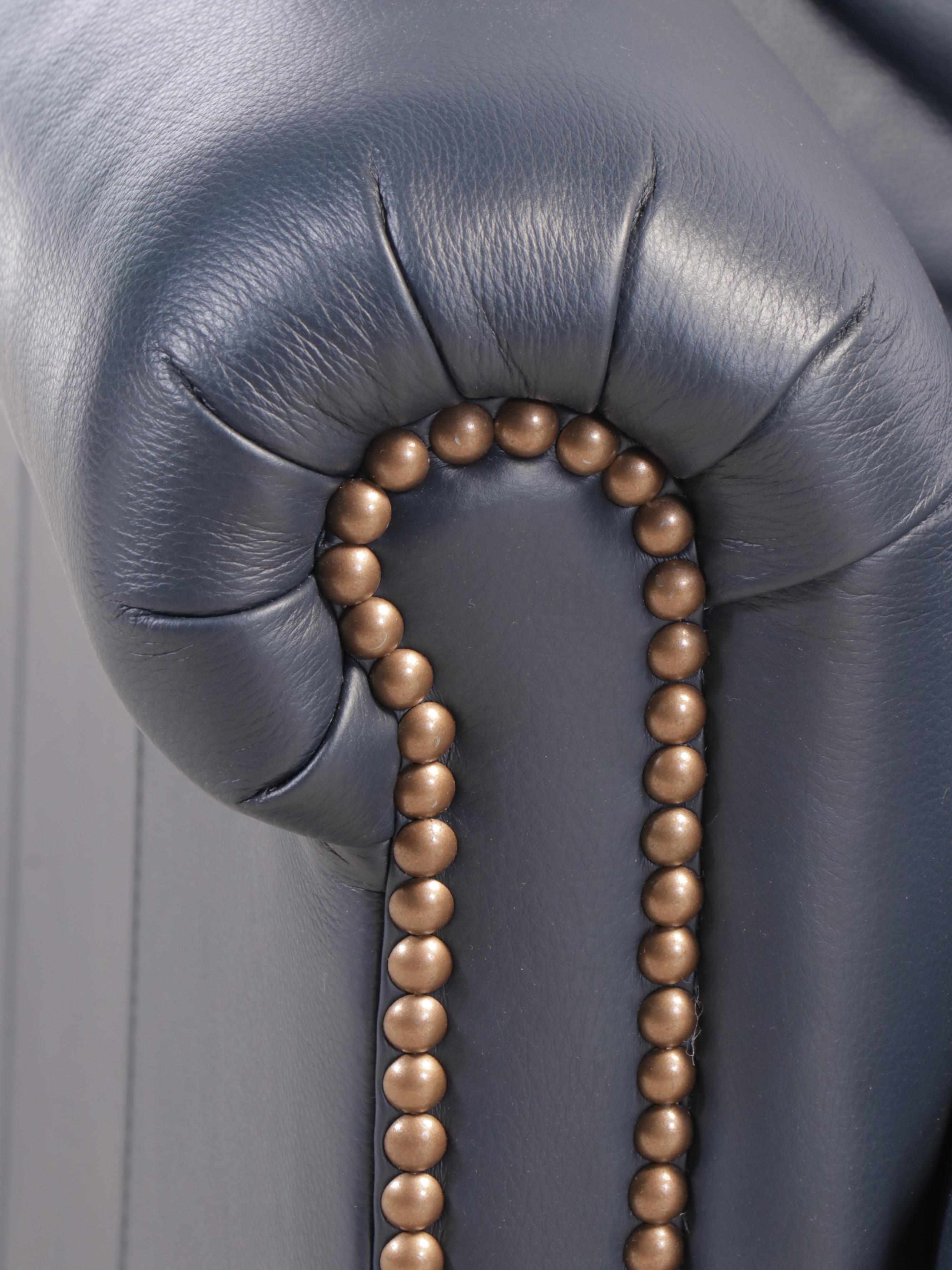 Designer's Choice Leather Upholstered Armchair and Ottoman with Nailhead Trim