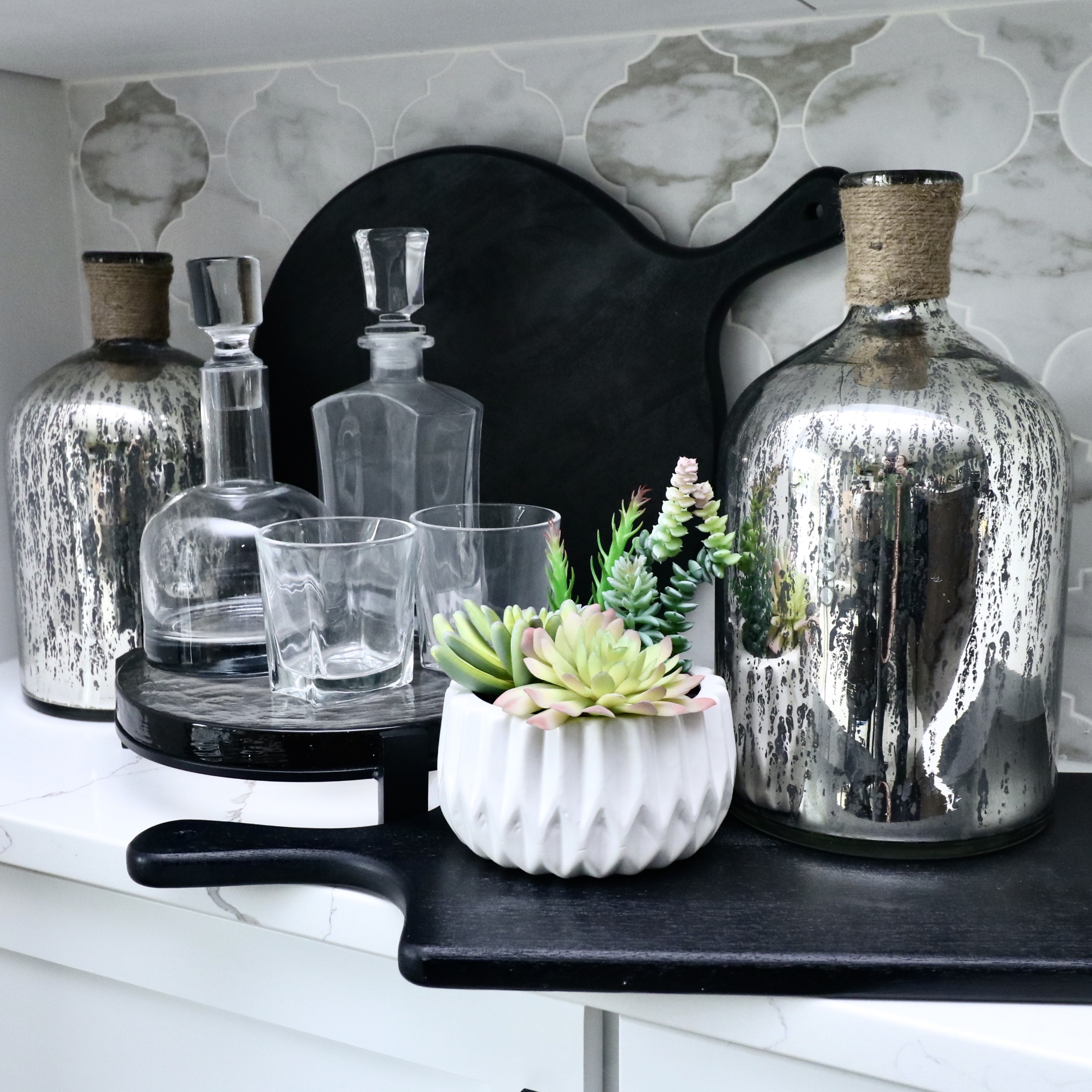 Footed Glass Tray with Decanters, Surya Mercury Glass Vases and Serving Boards