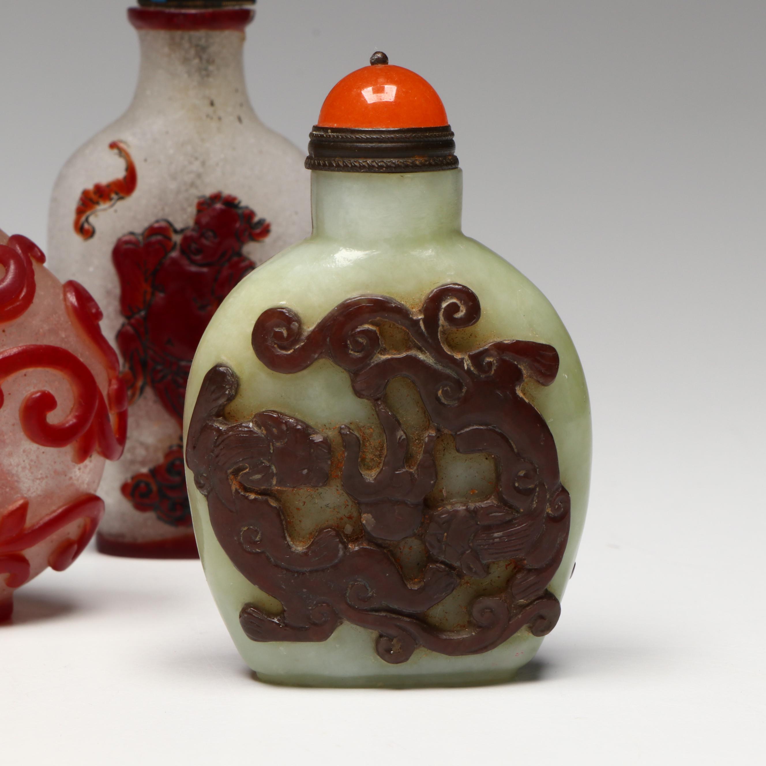 Chinese Carved Serpentine, Quartz and Coral Snuff Bottles