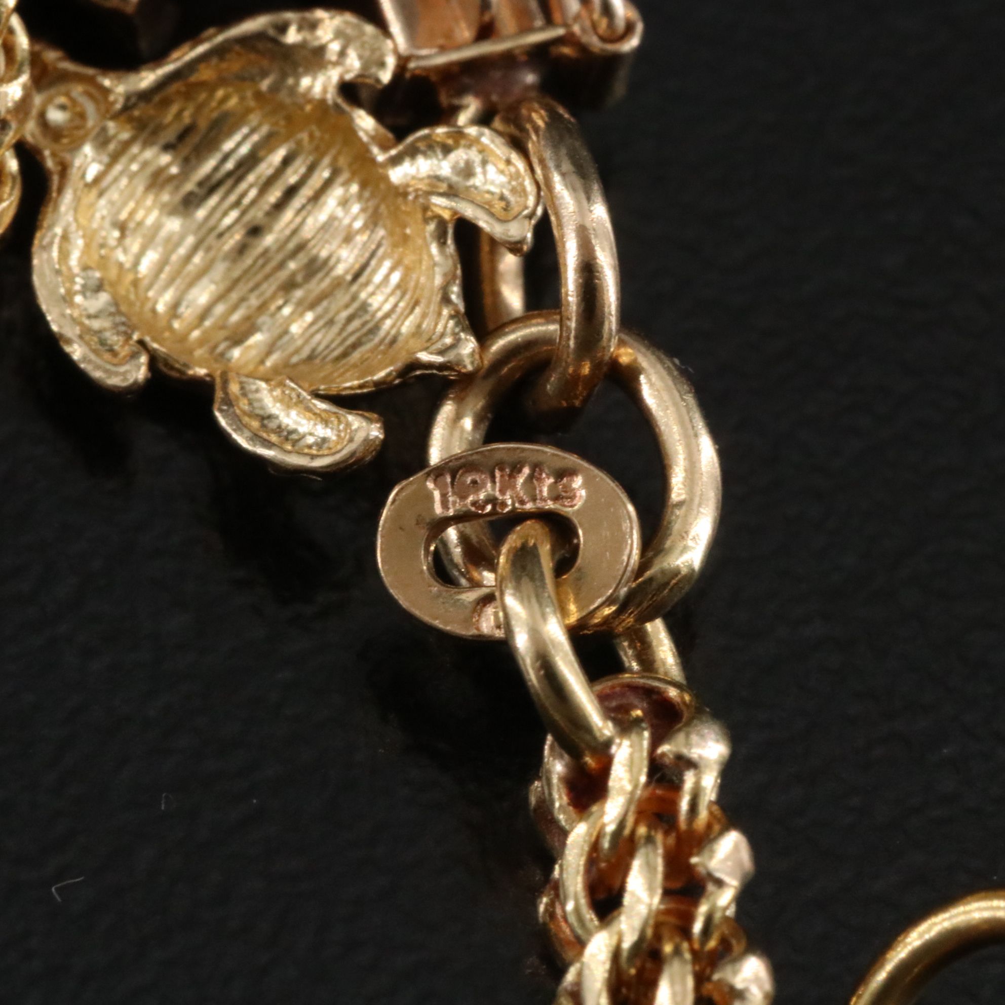 14K Charm Bracelet Including 10K, 18K and Articulated