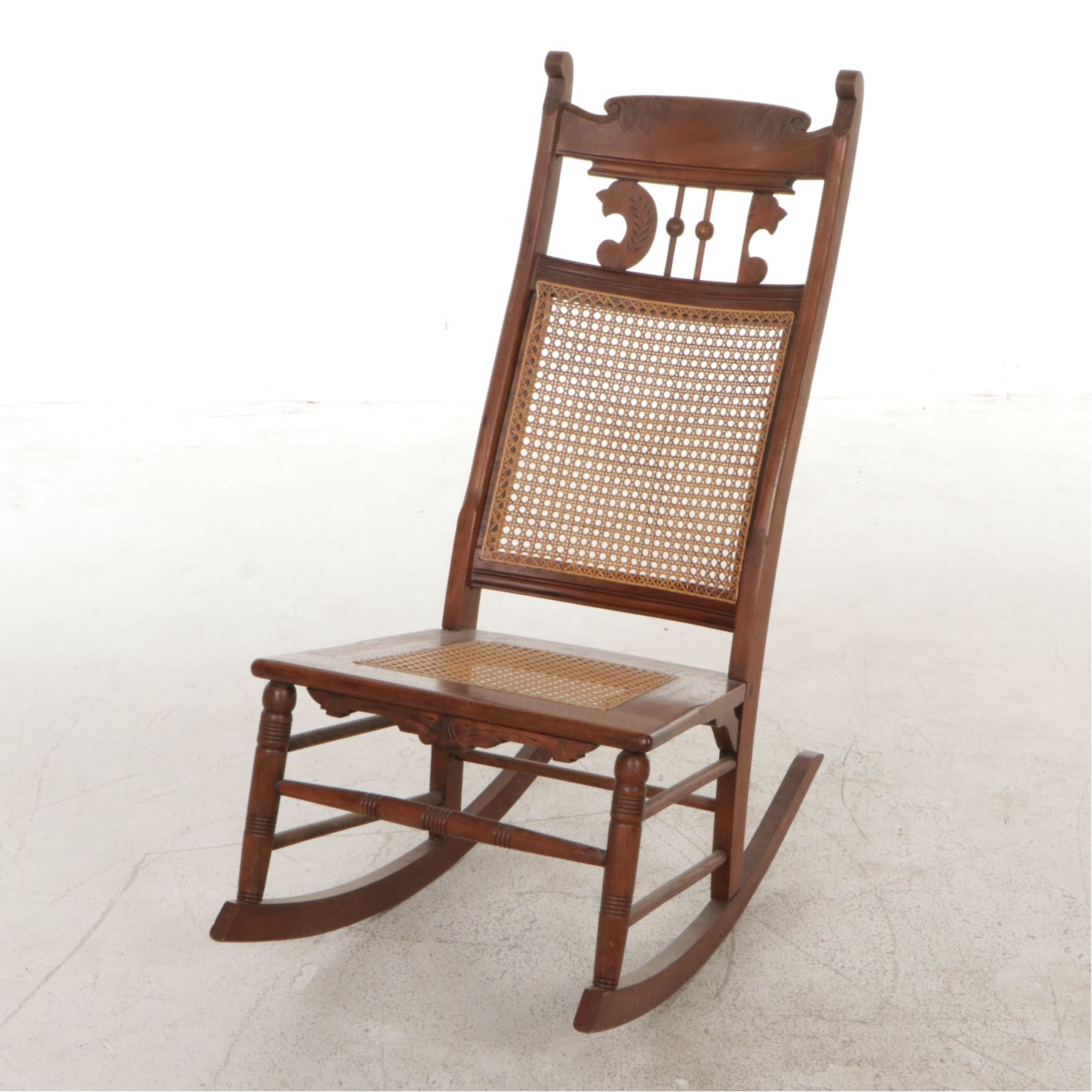 Cane and Carved Wood Rocking Chair