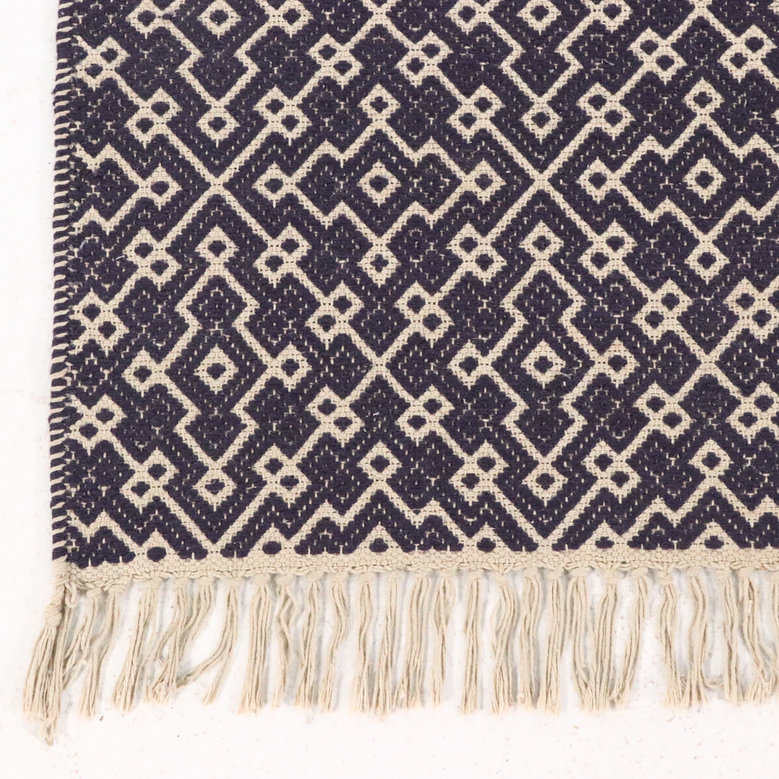 Navy Blue and White Geometric 4' x 7' Woven Tasseled Accent Rug