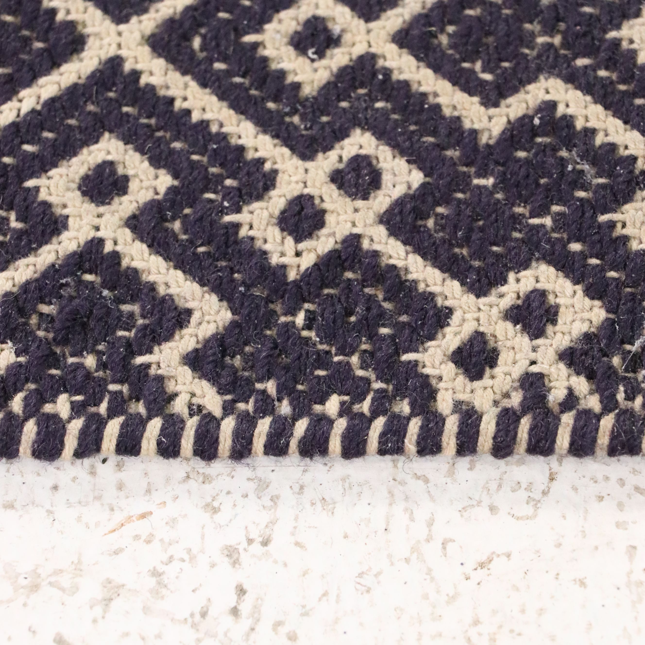 Navy Blue and White Geometric 4' x 7' Woven Tasseled Accent Rug