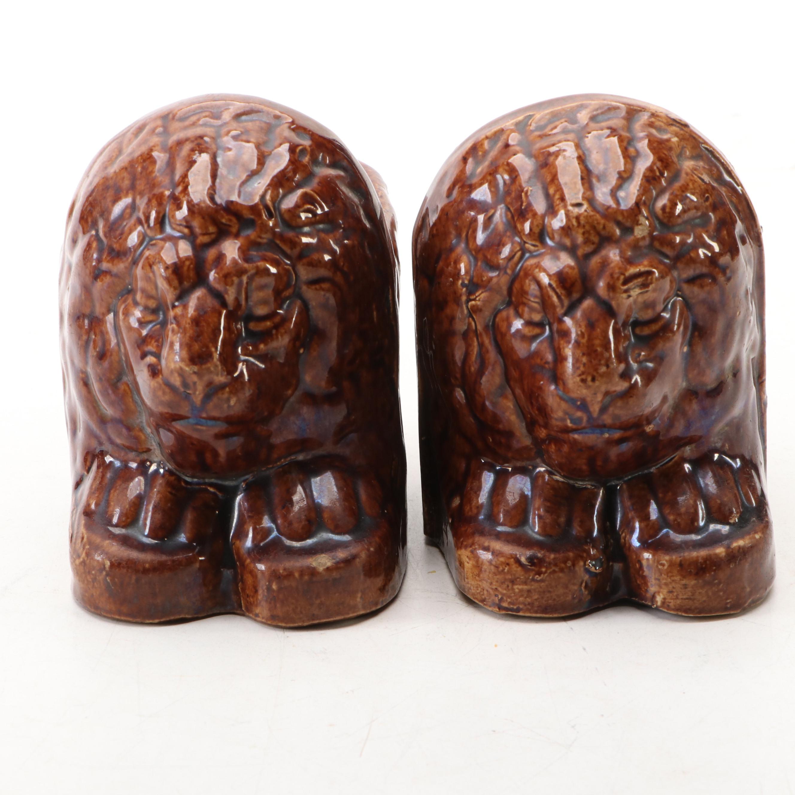 Pair of English Treacle Glaze Lion Head Window Sash Stops, 19th century