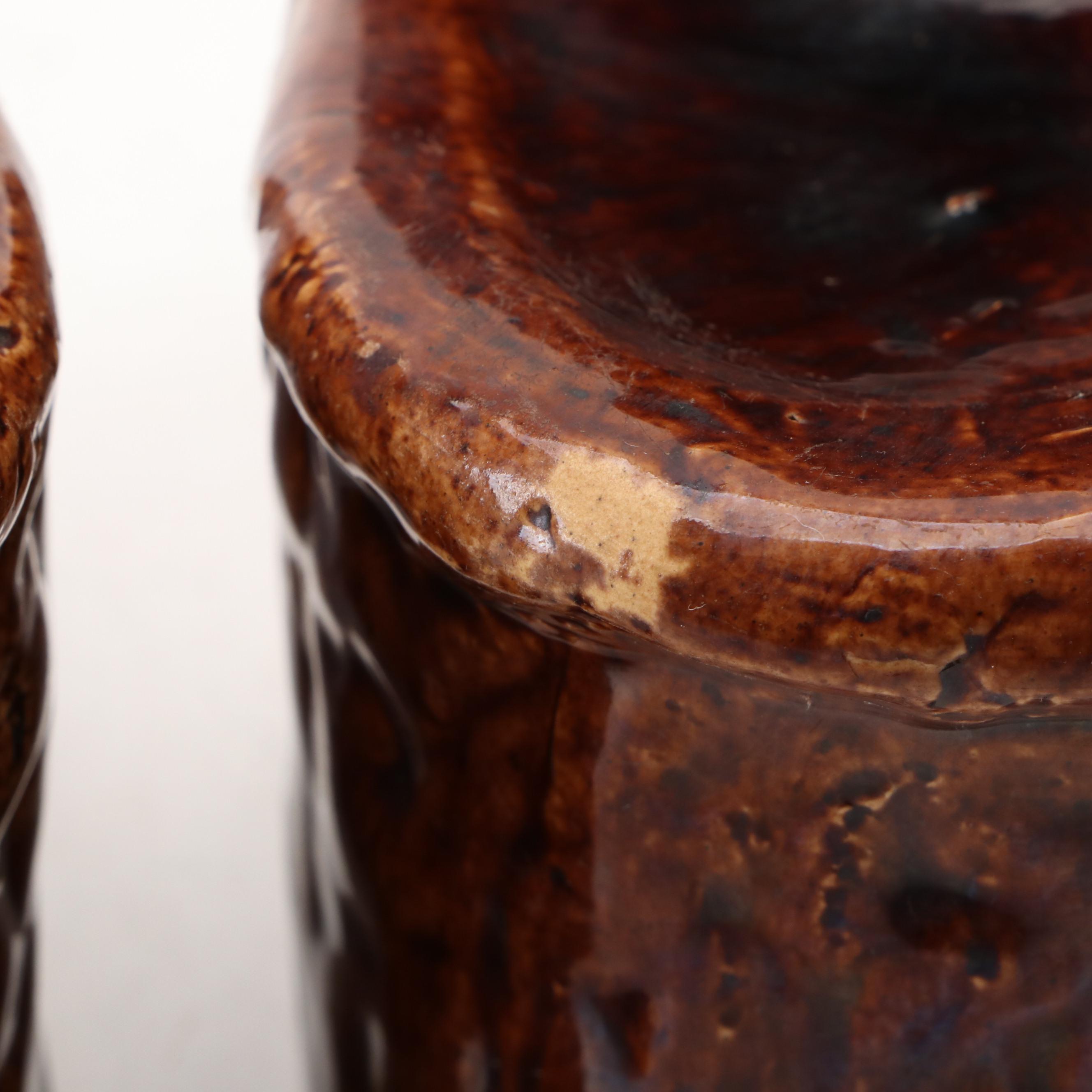 Pair of English Treacle Glaze Lion Head Window Sash Stops, 19th century