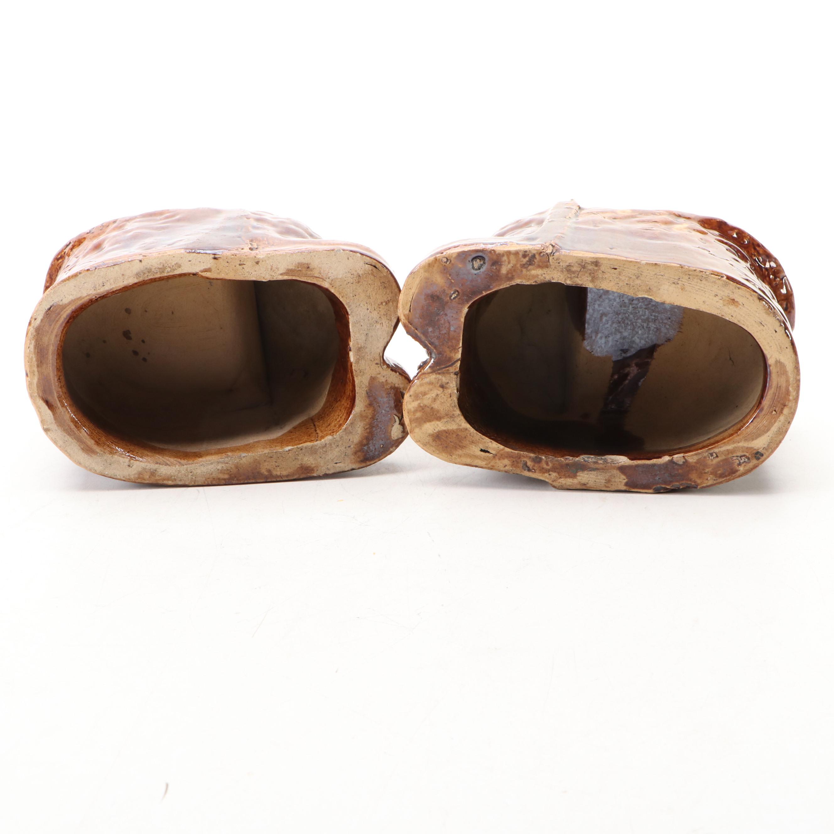 Pair of English Treacle Glaze Lion Head Window Sash Stops, 19th century