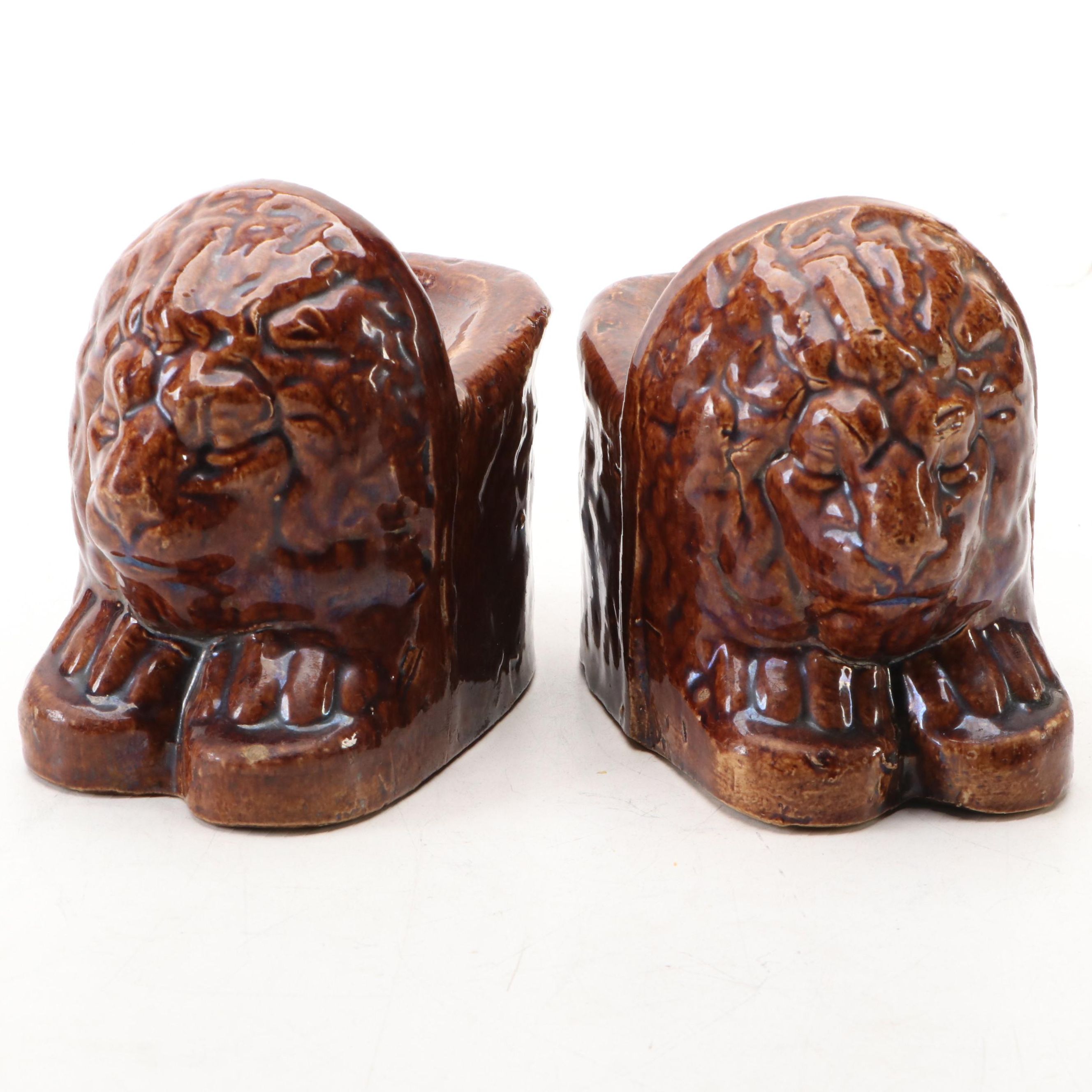 Pair of English Treacle Glaze Lion Head Window Sash Stops, 19th century