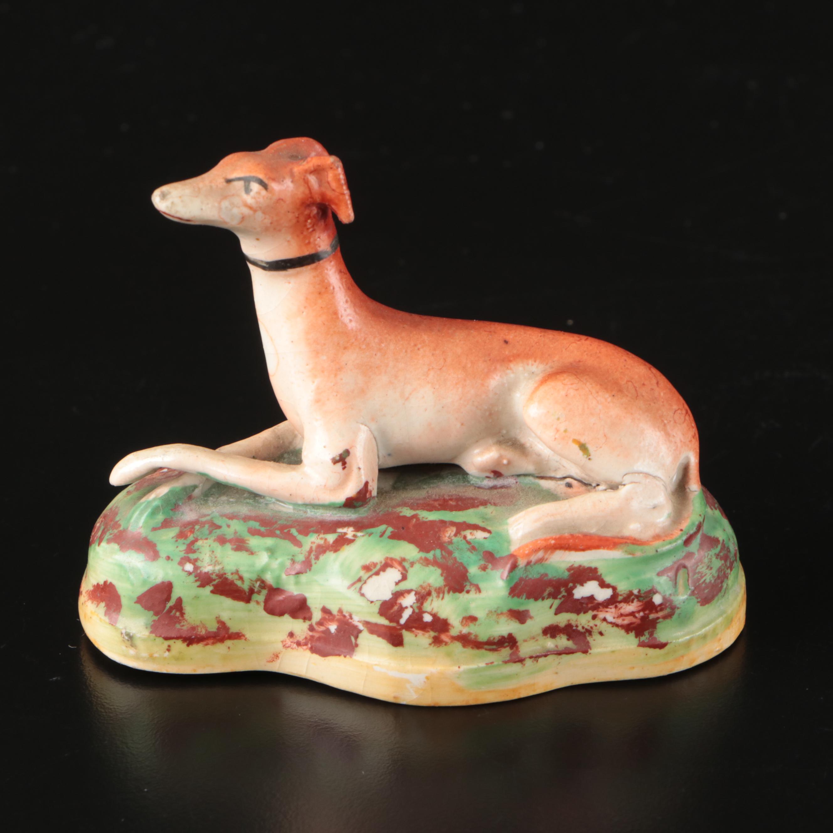 Staffordshire Reclining Greyhound with Other Figurines and Candle Holder