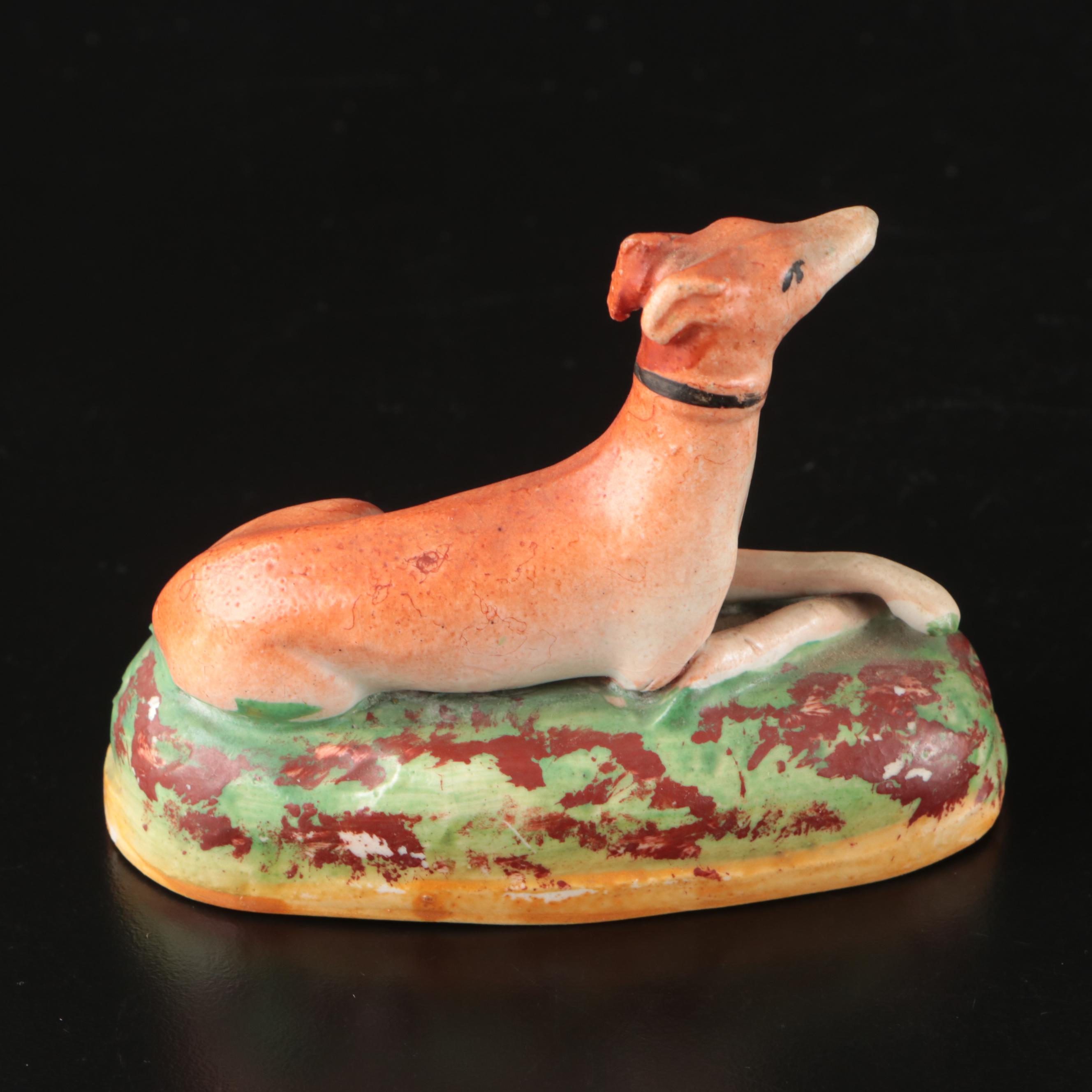 Staffordshire Reclining Greyhound with Other Figurines and Candle Holder