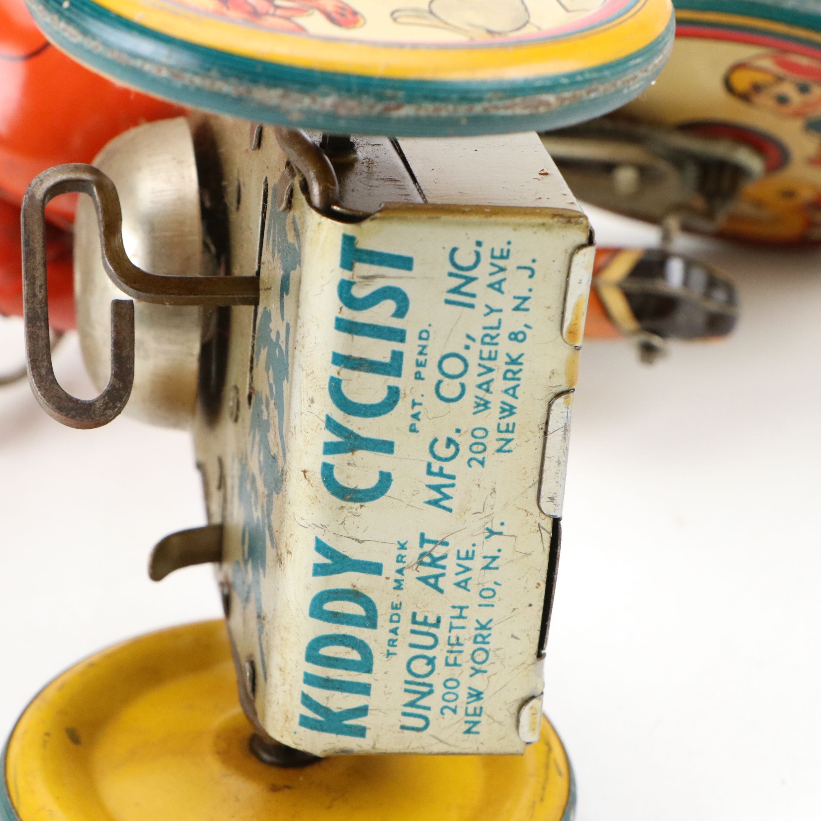 Unique Art Mfg. Co., Inc. "Kiddy Cyclist" Tin Wind-Up Toy, Mid-20th Century