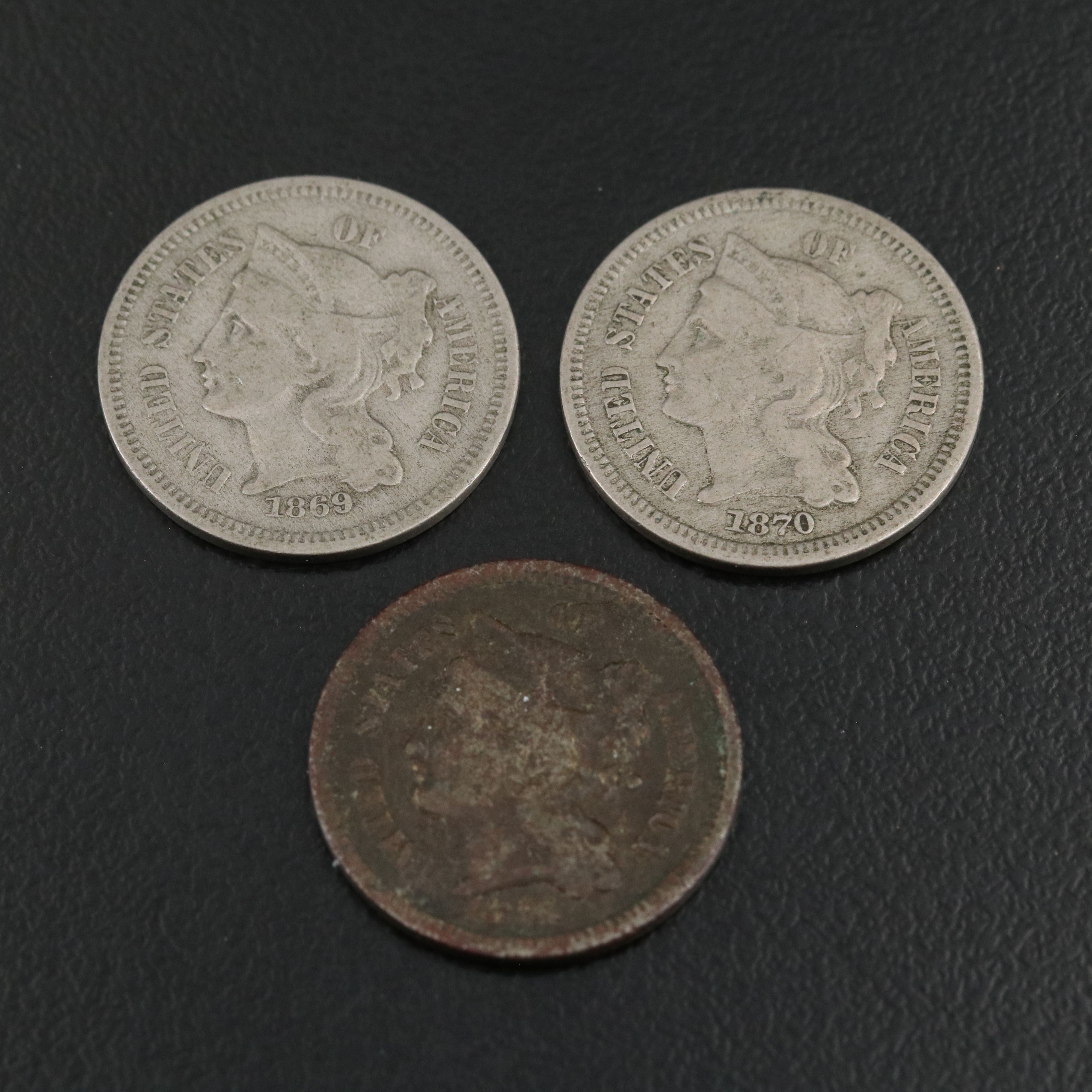 7 different U.S. three cent nickels 1865, 1866, 1867, 1868, 1869, 1870, and 1974